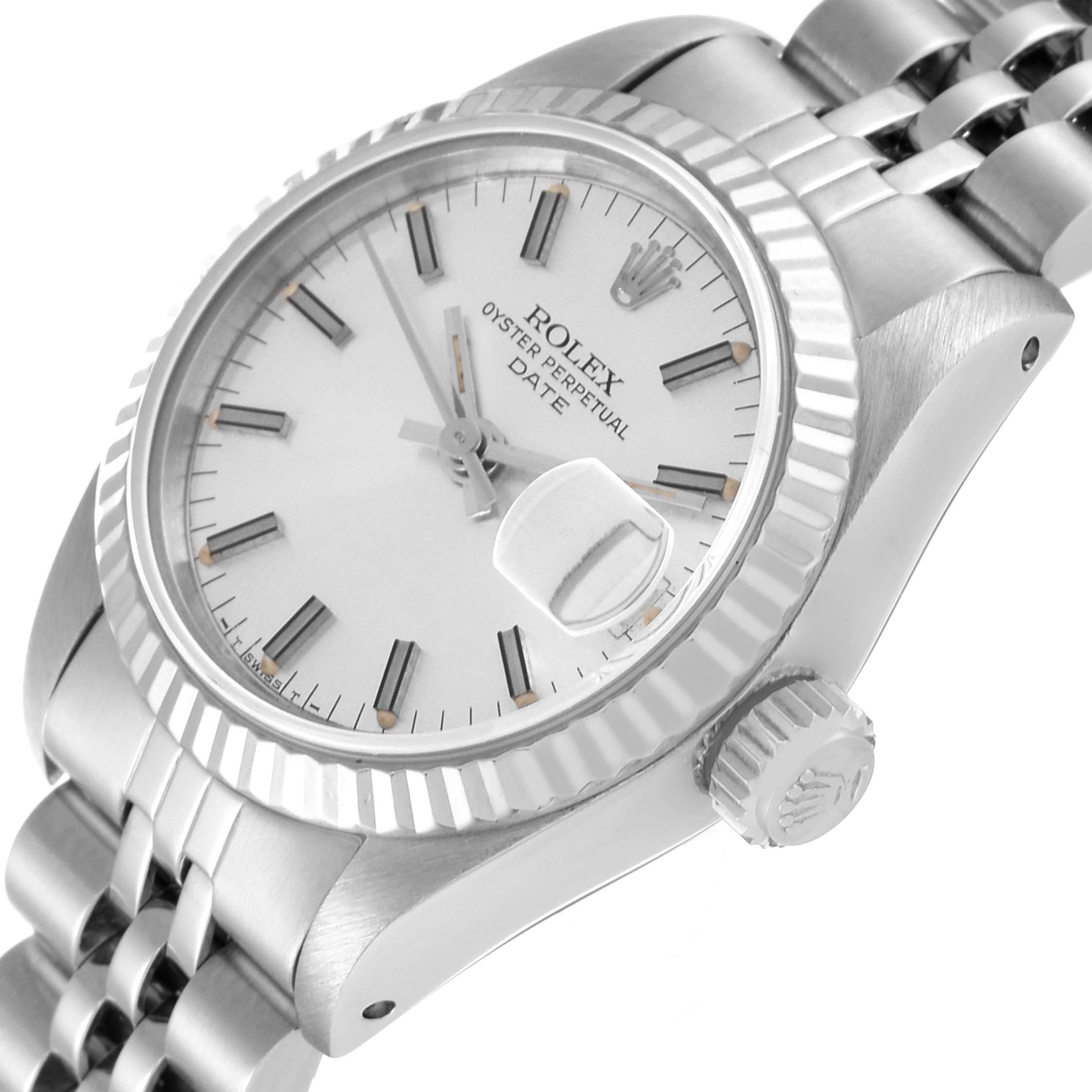The image shows a close-up angle of a Rolex Oyster Perpetual Date watch, focusing on the face, bezel, crown, and part of the bracelet.