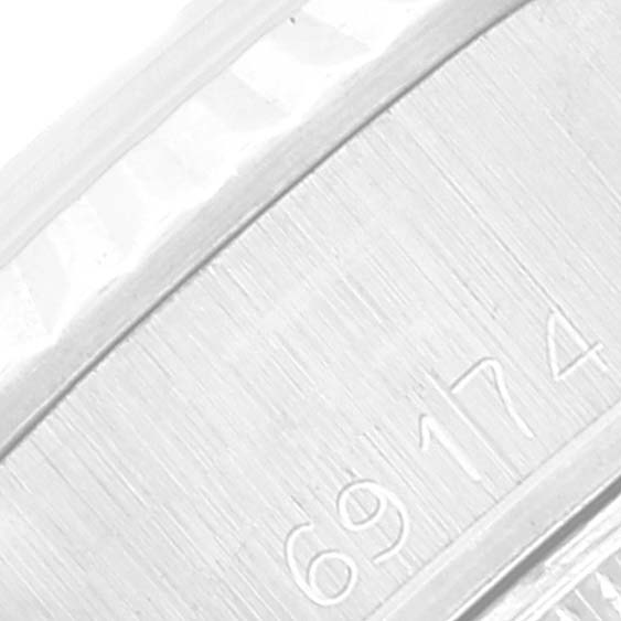 The image shows a close-up of the serial number area of the band of the Rolex Date 69174 Women
s Stainless Steel Silver Dial 69174 Women
s Stainless Steel Silver Dial model watch.