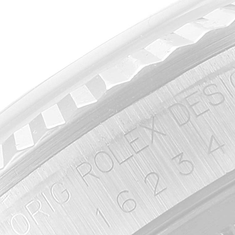 This image shows a close-up of the fluted bezel and engraved text on the side of the Rolex Datejust 16234 Men's Stainless Steel Silver Dial 16234 Men's Stainless Steel Silver Dial watch case.