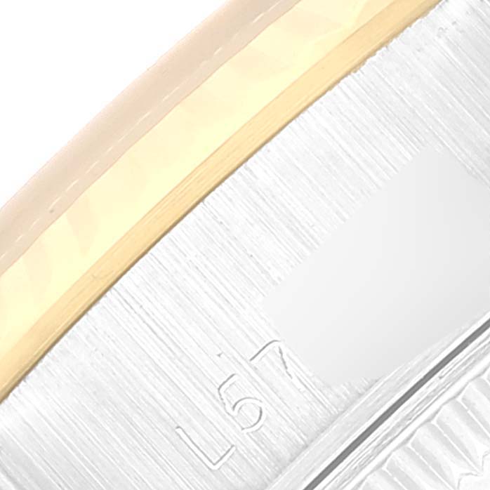 The image shows a close-up of the side of a Rolex Datejust 69173 Women's Steel and Gold (two tone) Champagne Dial 69173 Women's Steel and Gold (two tone) Champagne Dial watch, featuring part of the bezel and case with engraved markings.