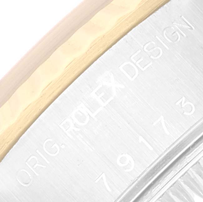 This image shows a close-up of the case side and rim of the Rolex Datejust 79173 Women's Steel and Gold (two tone) Champagne Dial 79173 Women's Steel and Gold (two tone) Champagne Dial watch, highlighting the "ROLEX DESIGN" engraving.