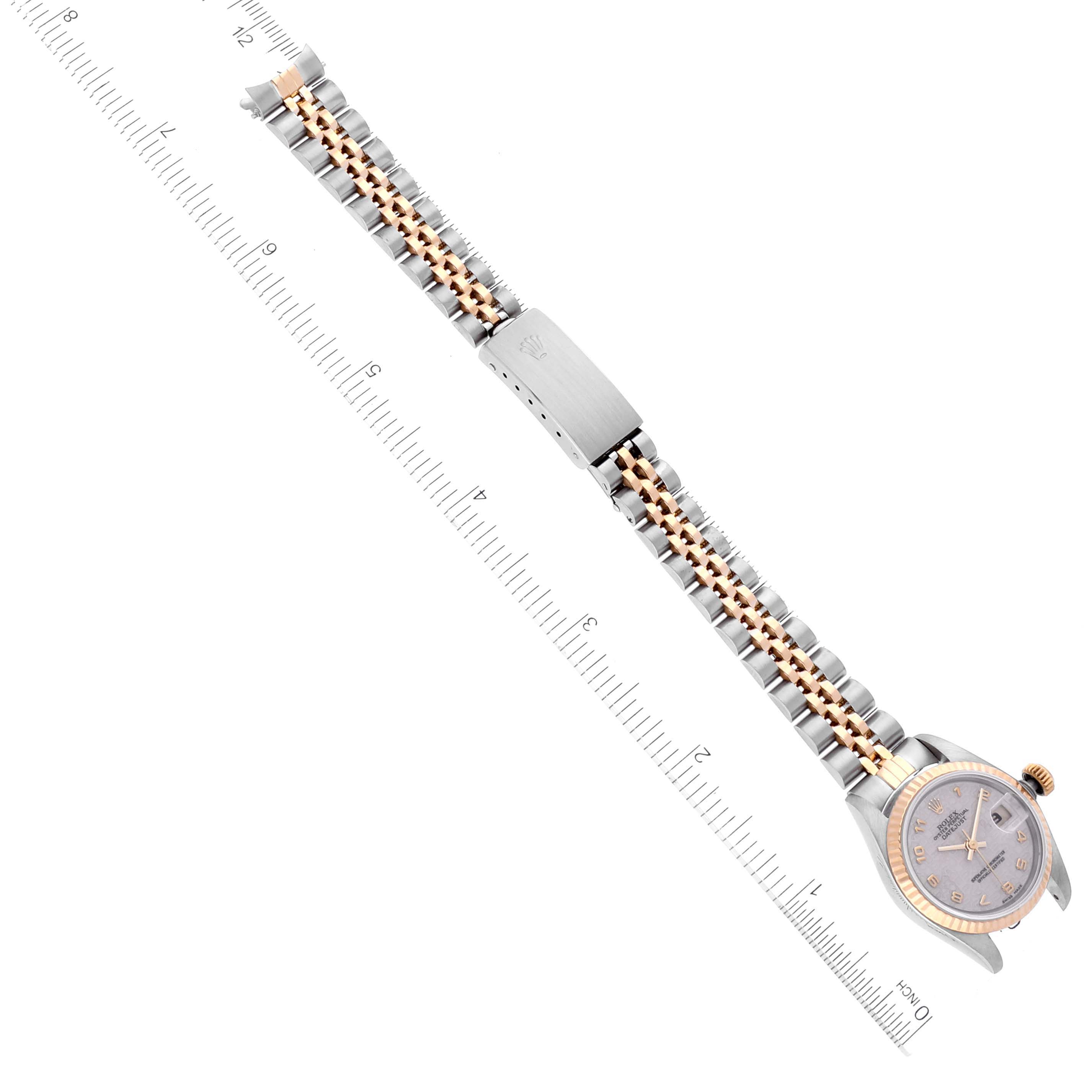 The image shows a Datejust model Rolex watch with a jubilee bracelet, positioned horizontally against a ruler for scale.