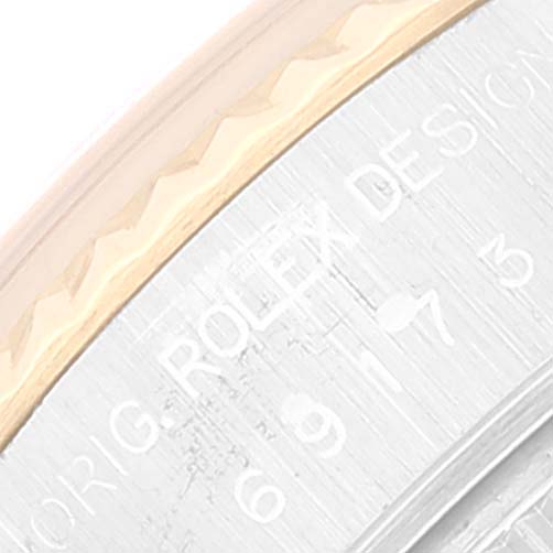 The image shows a close-up of the bezel and part of the case of a Rolex Datejust 69173 Women's Steel and Gold (two tone) Beige Dial 69173 Women's Steel and Gold (two tone) Beige Dial watch, with the "ROLEX" design engraving visible.