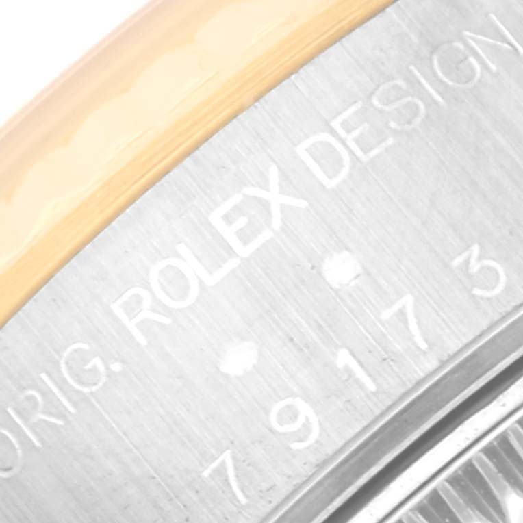 This image shows a macro shot of the caseback of a Rolex Datejust 79173 Women's Steel and Gold (two tone) White Dial 79173 Women's Steel and Gold (two tone) White Dial watch, focusing on the engraved text.