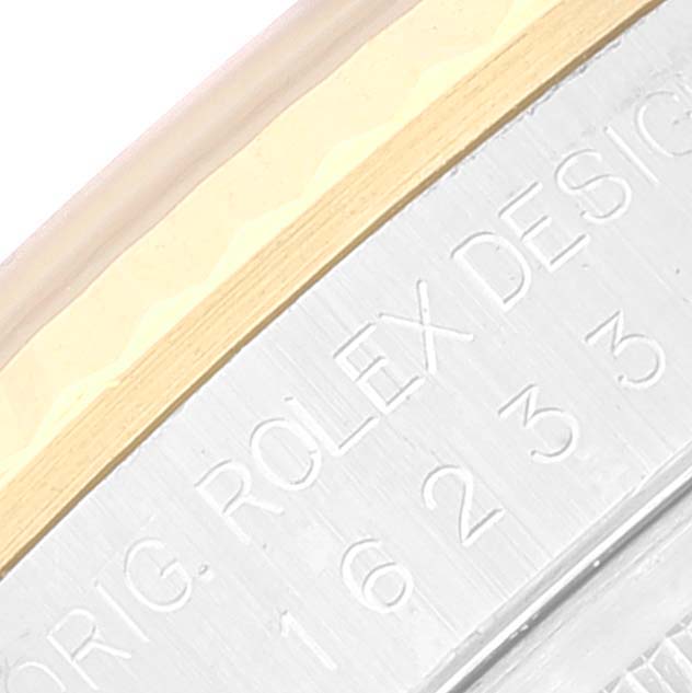 This close-up image shows part of the bezel and engraved case of a Rolex Datejust 16233 Men's Steel and Gold (two tone) White Dial 16233 Men's Steel and Gold (two tone) White Dial watch.