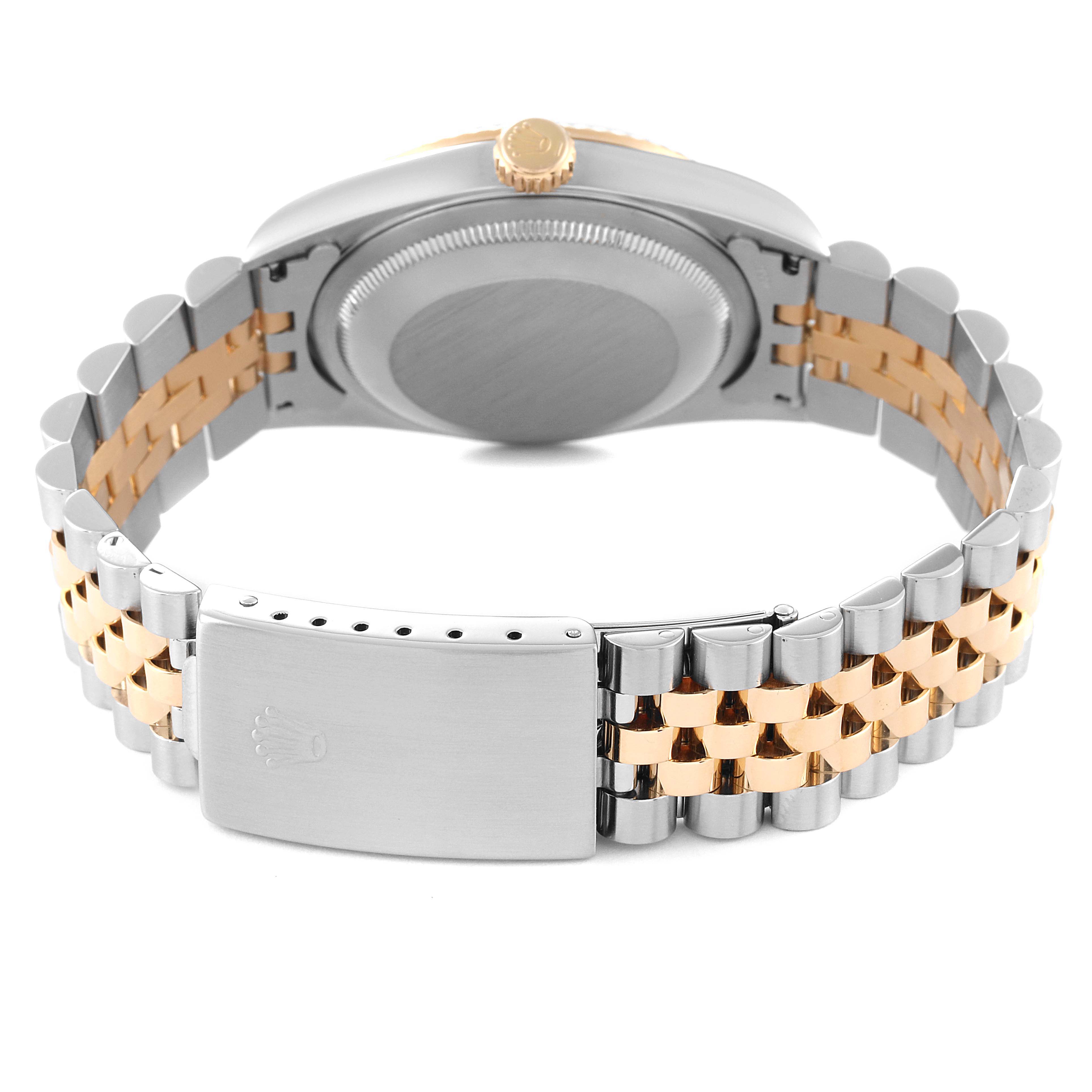 The image shows the back of a Rolex Datejust 16233 Men's Steel and Gold (two tone) White Dial 16233 Men's Steel and Gold (two tone) White Dial watch, highlighting the case, crown, and two-tone metal bracelet with a clasp.