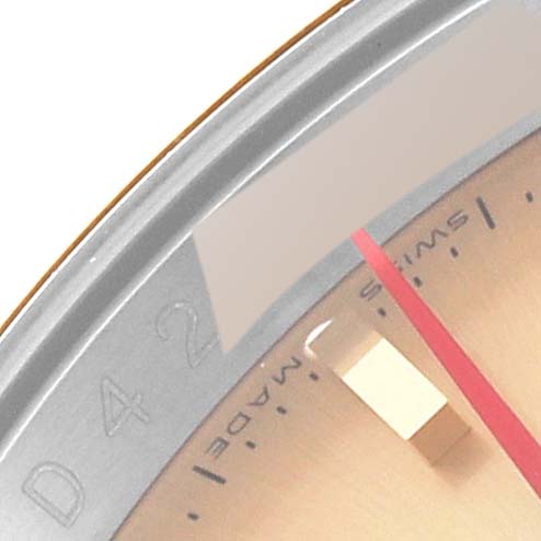 This image shows a close-up view of the Rolex Turn-o-Graph 116263 Men's Steel and Gold (two tone) Champagne Dial 116263 Men's Steel and Gold (two tone) Champagne Dial watch face, highlighting part of the dial, hands, and bezel.