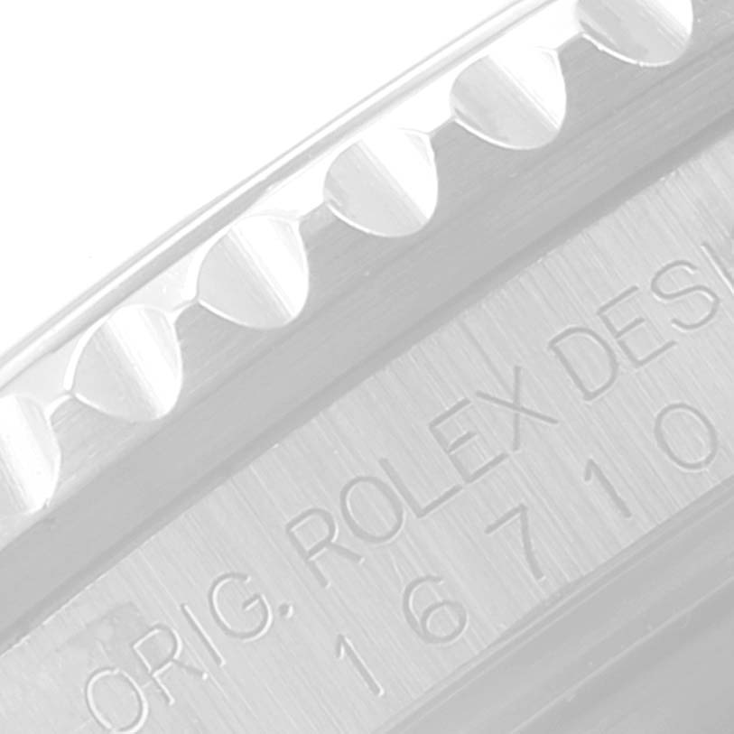 This close-up image shows part of the bezel and engraved serial number on a Rolex GMT-Master 16710 Men
s Stainless Steel Black Dial 16710 Men
s Stainless Steel Black Dial model watch.