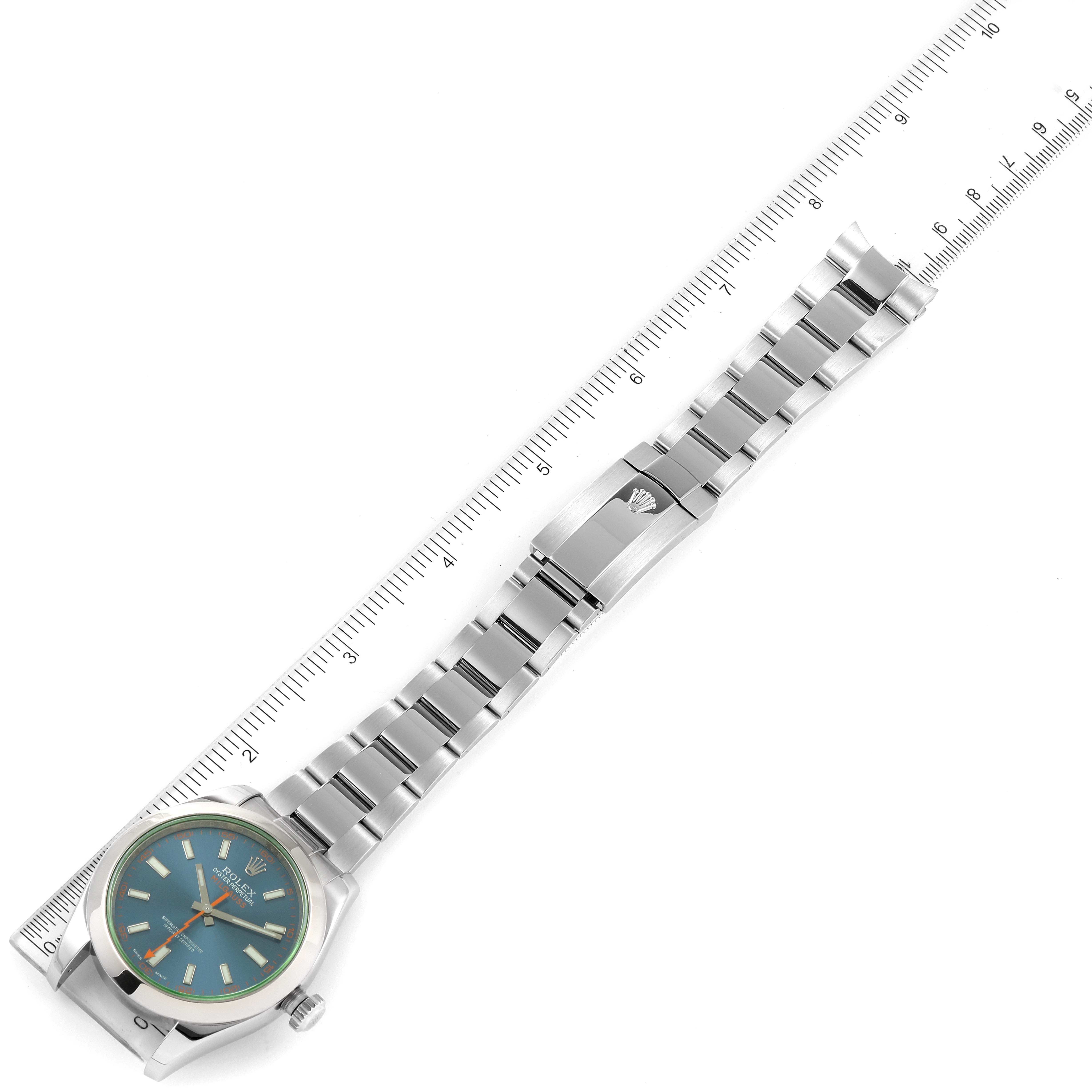 The image shows an overhead view of a Rolex Milgauss 116400GV Men
s Stainless Steel Blue Dial 116400GV Men
s Stainless Steel Blue Dial watch with its face, bracelet, and clasp displayed next to a ruler.