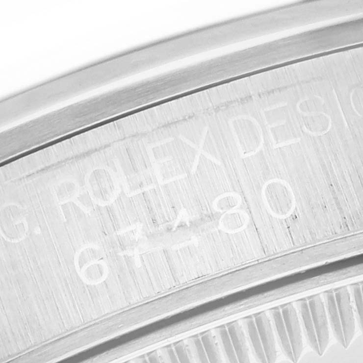 The image shows a close-up of the case side and engraved details of a mid-size Rolex watch.
