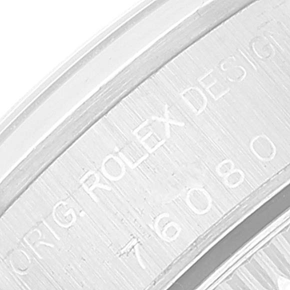 This close-up image shows the engraved text on the case back edge of a Rolex Oyster Perpetual 76080 Women
s Stainless Steel Pink Dial 76080 Women
s Stainless Steel Pink Dial watch.