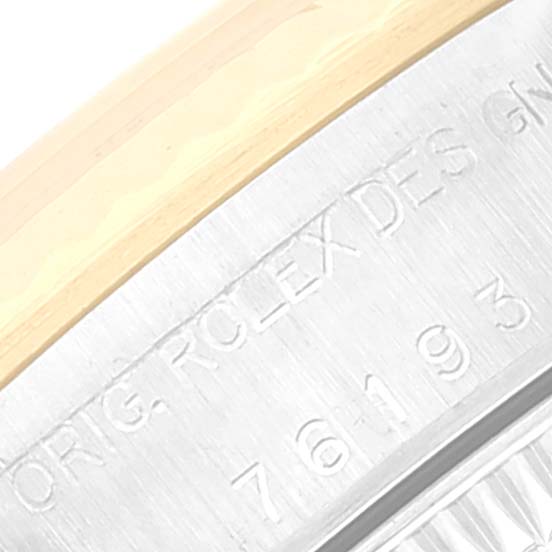 This image shows a close-up of the engraved side of the bezel and case of a Rolex Oyster Perpetual 76193 Women
s Steel and Gold (two tone) Blue Dial 76193 Women
s Steel and Gold (two tone) Blue Dial watch.