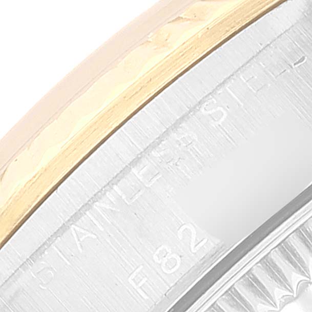 This image shows a close-up of the bezel and part of the case back of a Rolex Oyster Perpetual 76193 Women
s Steel and Gold (two tone) Blue Dial 76193 Women
s Steel and Gold (two tone) Blue Dial watch.