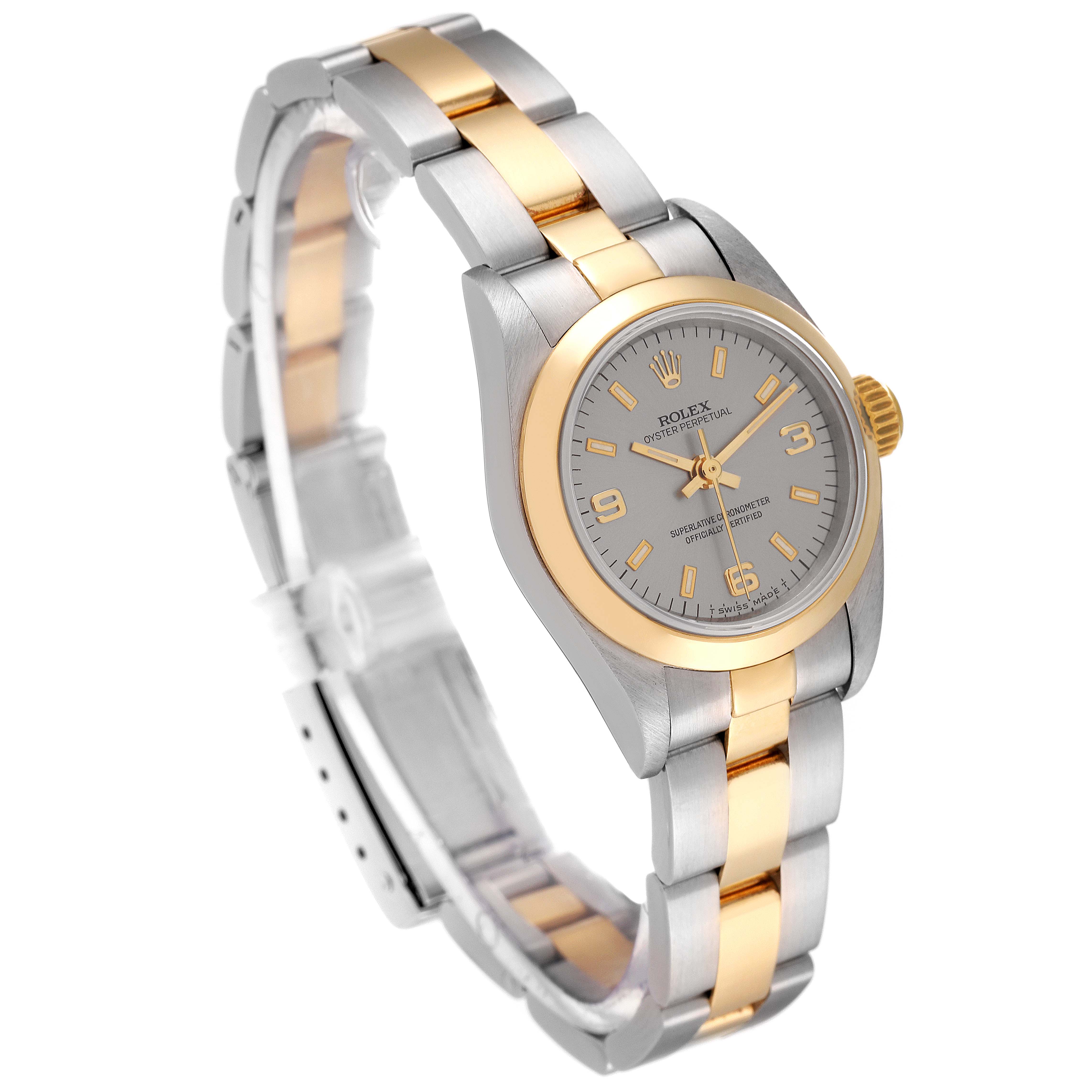 The Rolex Oyster Perpetual 67183 Women's Steel and Gold (two tone) Silver Dial 67183 Women's Steel and Gold (two tone) Silver Dial watch is shown at an oblique angle, highlighting the two-tone bracelet and the watch face.