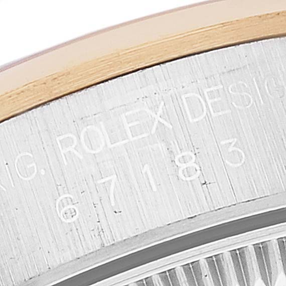 This image shows a close-up view of the side bezel of a Rolex Oyster Perpetual 67183 Women's Steel and Gold (two tone) Silver Dial 67183 Women's Steel and Gold (two tone) Silver Dial watch, highlighting the engraved text.