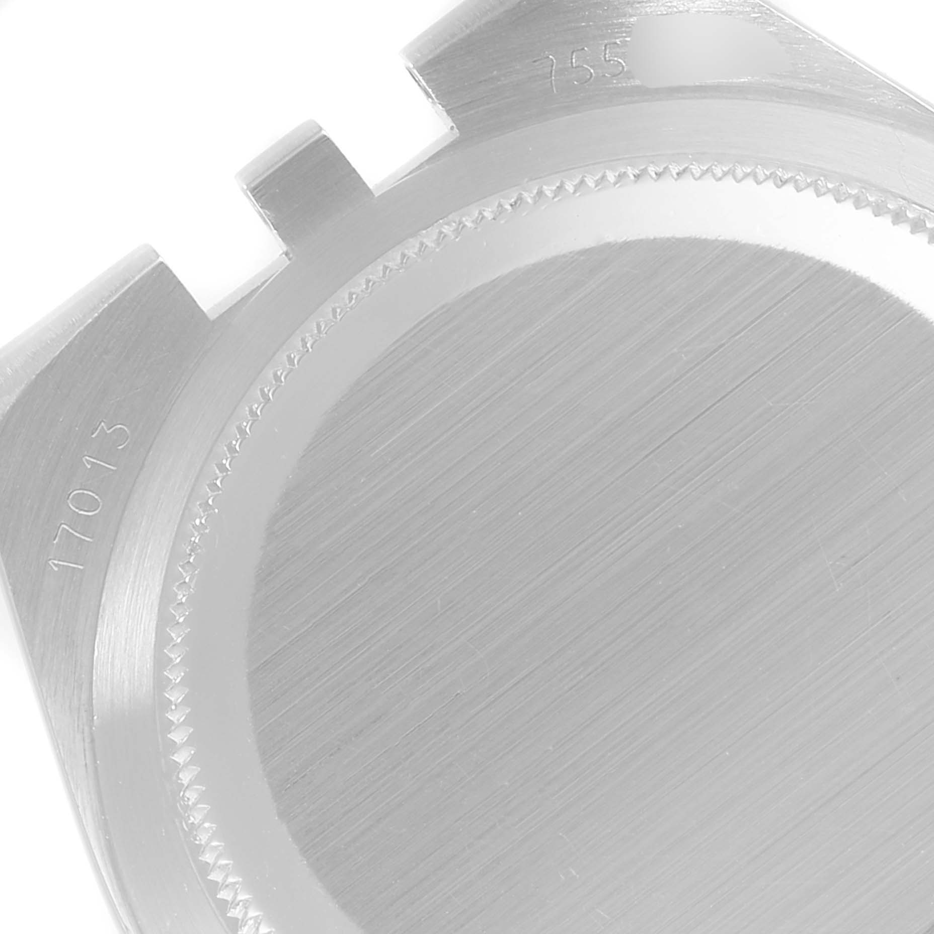 This image shows the case back of a Rolex Oysterquartz 17013 Men's Steel and Gold (two tone) White Dial 17013 Men's Steel and Gold (two tone) White Dial model viewed from a top-down angle, highlighting its detailed engravings.