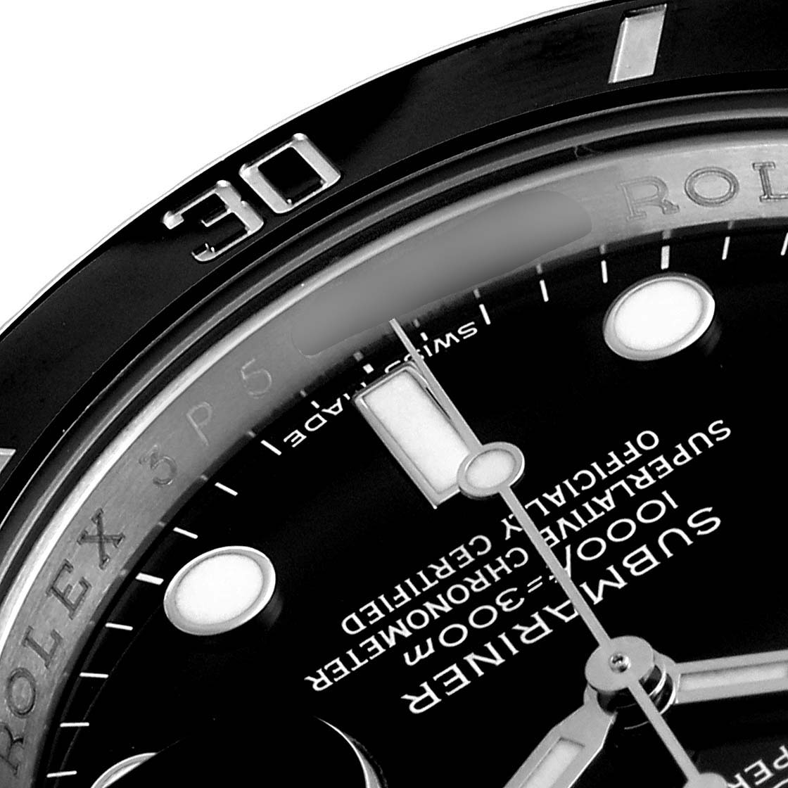 The image displays a close-up of the face and bezel of a Rolex Submariner 116610LN Men's Stainless Steel Black Dial 116610LN Men's Stainless Steel Black Dial watch, focusing on the hour markers and minute hand.