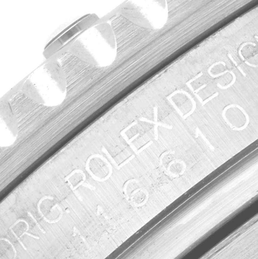 This image shows a close-up of the Rolex Submariner 116610LV Men's Stainless Steel Green Dial 116610LV Men's Stainless Steel Green Dial's outer bezel and engraved design details on its side.