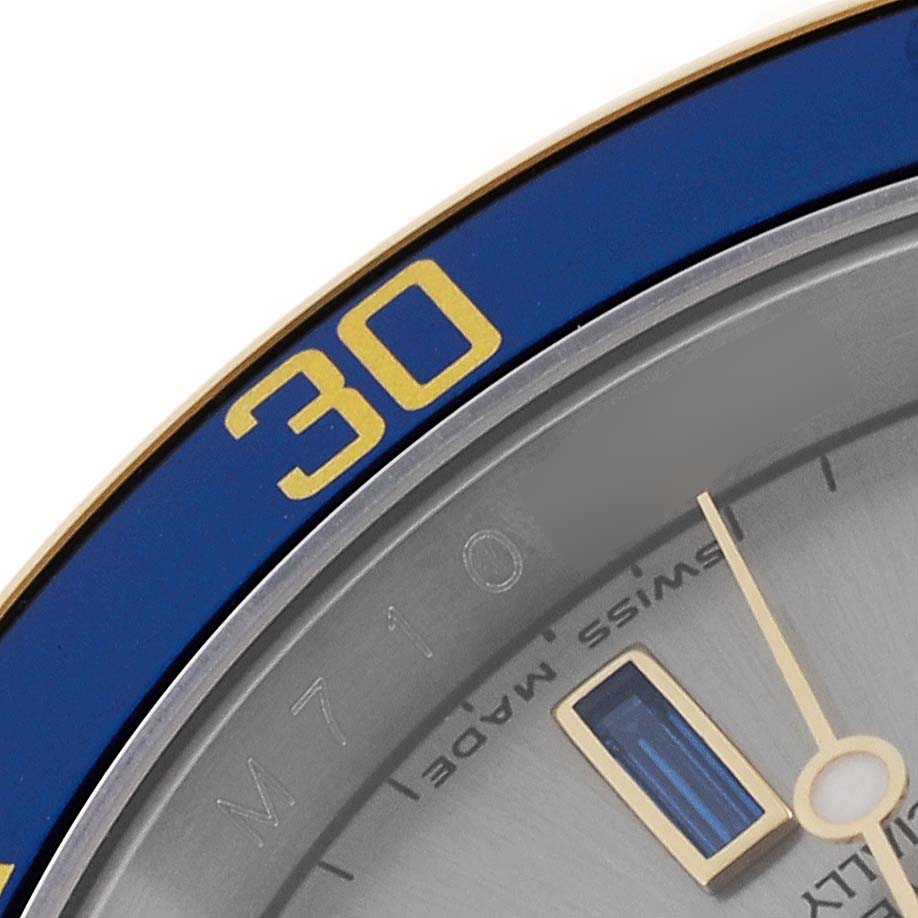 This close-up angle of the Rolex Submariner 16613 Men
s Steel and Gold (two tone) Grey Dial 16613 Men
s Steel and Gold (two tone) Grey Dial shows part of the dial and the numeral "30" on the blue bezel.