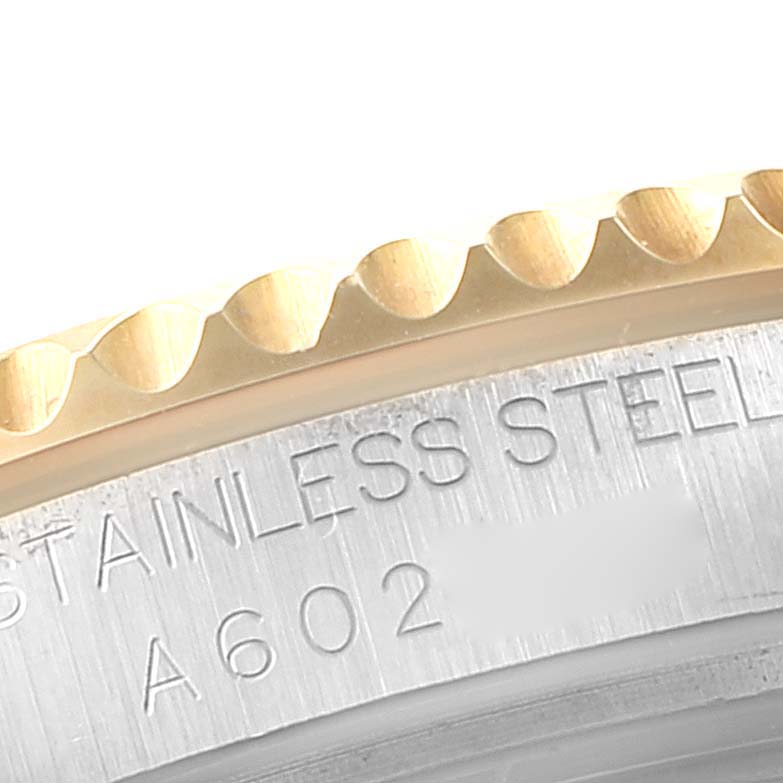 The image shows a close-up of the stainless steel and gold bezel of a Rolex Yacht-Master 168623 Men
s Steel and Gold (two tone) Grey Dial 168623 Men
s Steel and Gold (two tone) Grey Dial watch.