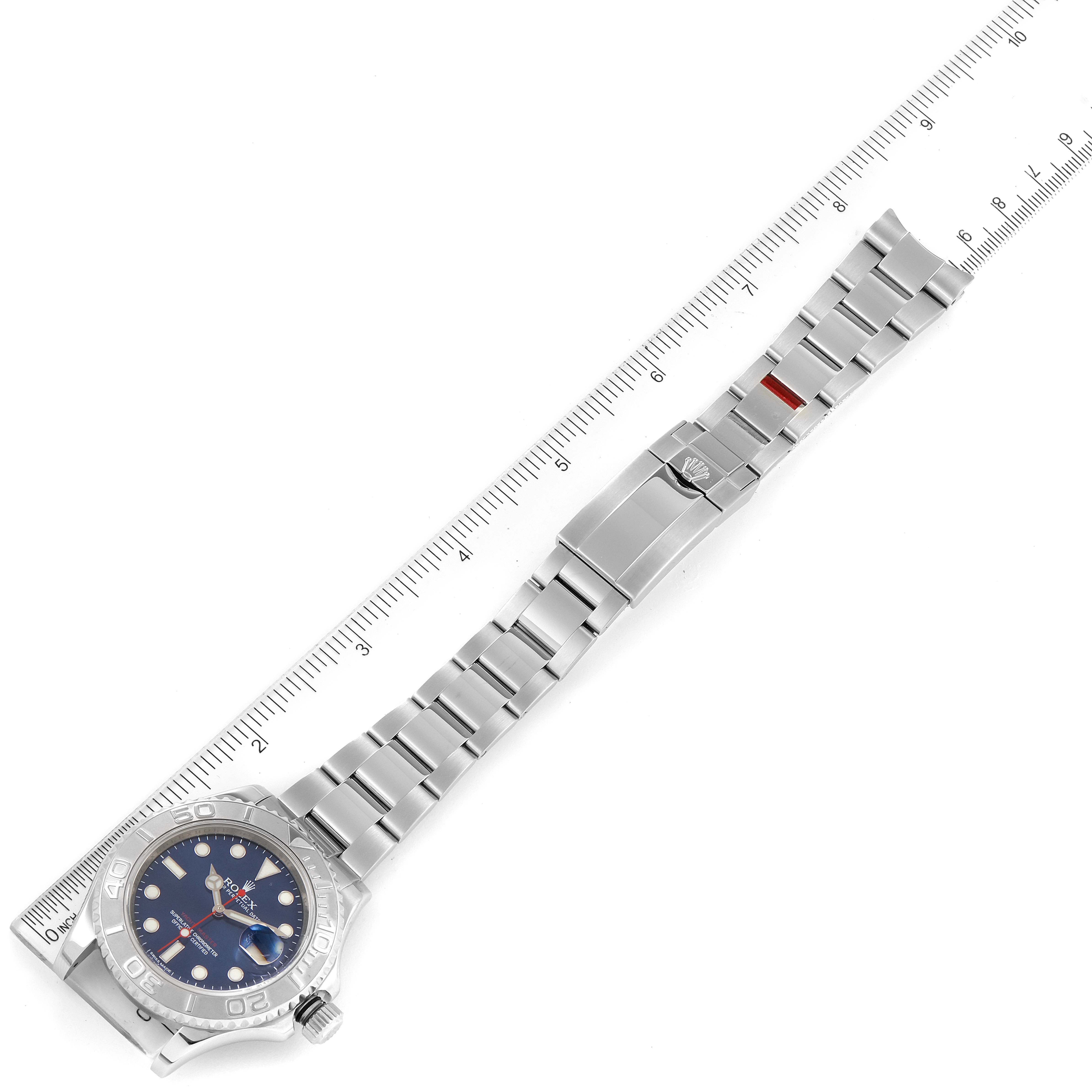 The image shows the Rolex Yacht-Master 116622 Men
s Stainless Steel Blue Dial 116622 Men
s Stainless Steel Blue Dial watch laid flat with a ruler for scale.