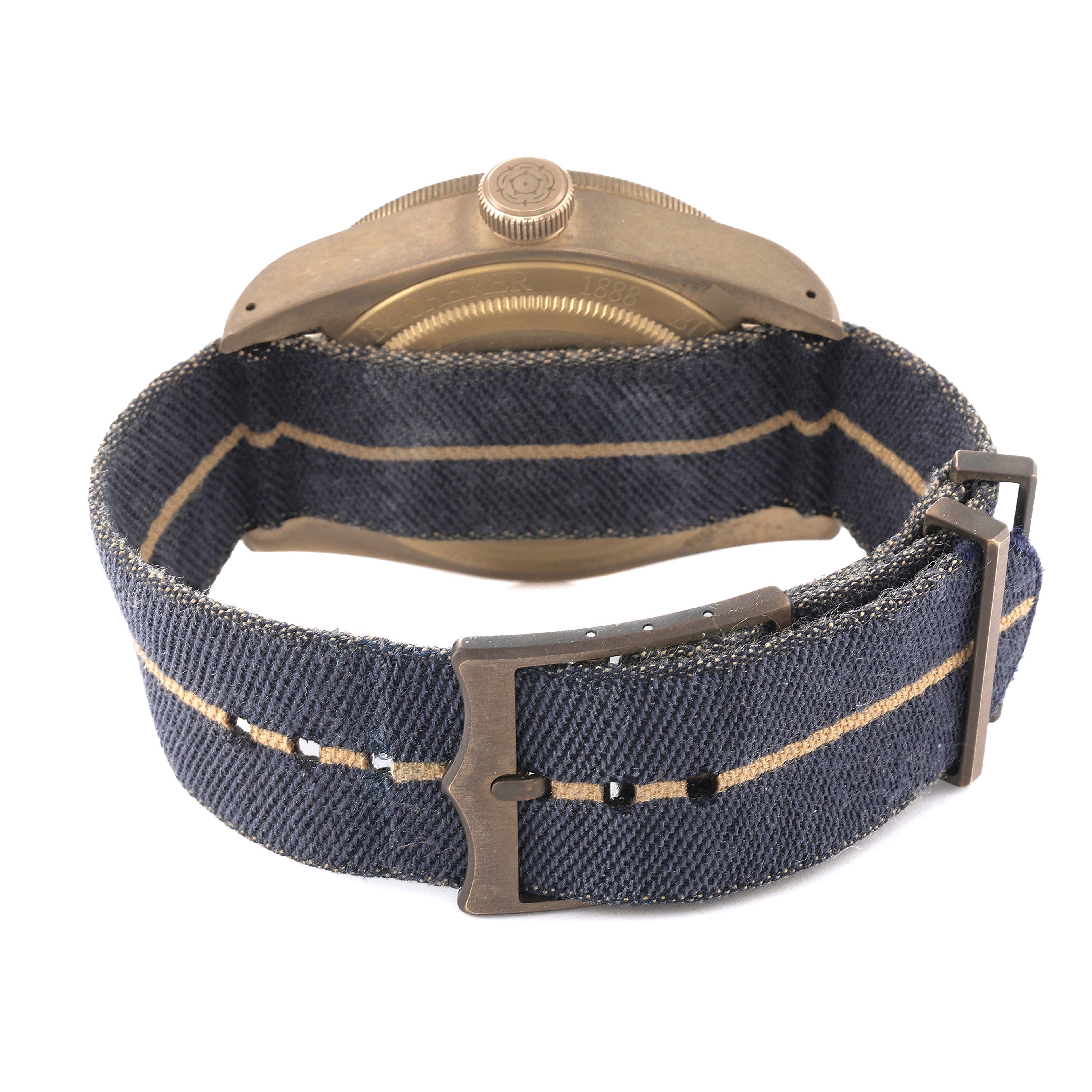 This image shows the back of the Tudor Heritage Black Bay 79250BB Men's Ceramic Blue Dial 79250BB Men's Ceramic Blue Dial watch, highlighting its case back and fabric strap with clasp.