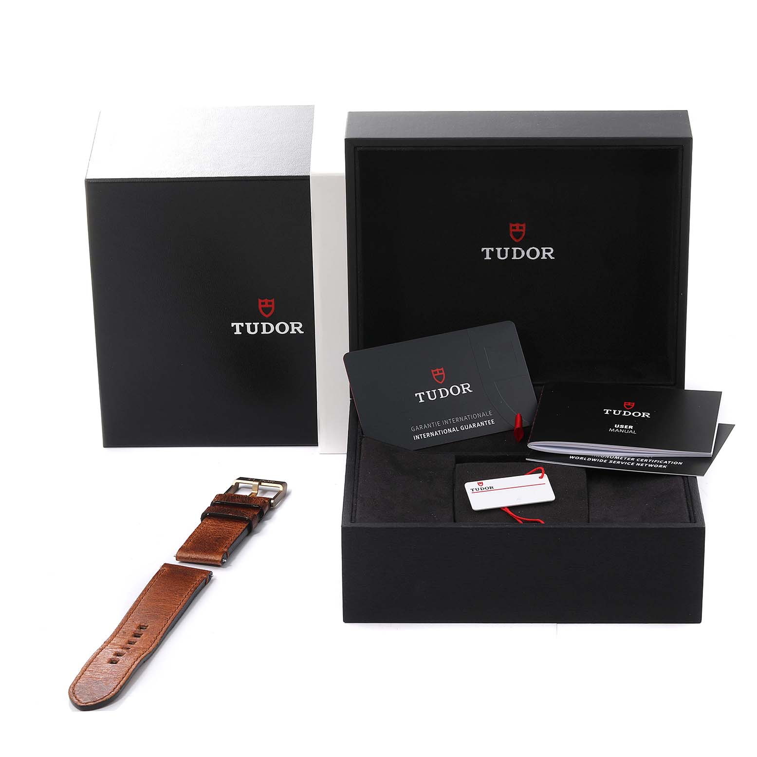 The image shows the packaging components of a Tudor Heritage Black Bay 79250BB Men's Ceramic Blue Dial 79250BB Men's Ceramic Blue Dial watch, including the box, leather strap, manuals, and warranty cards.