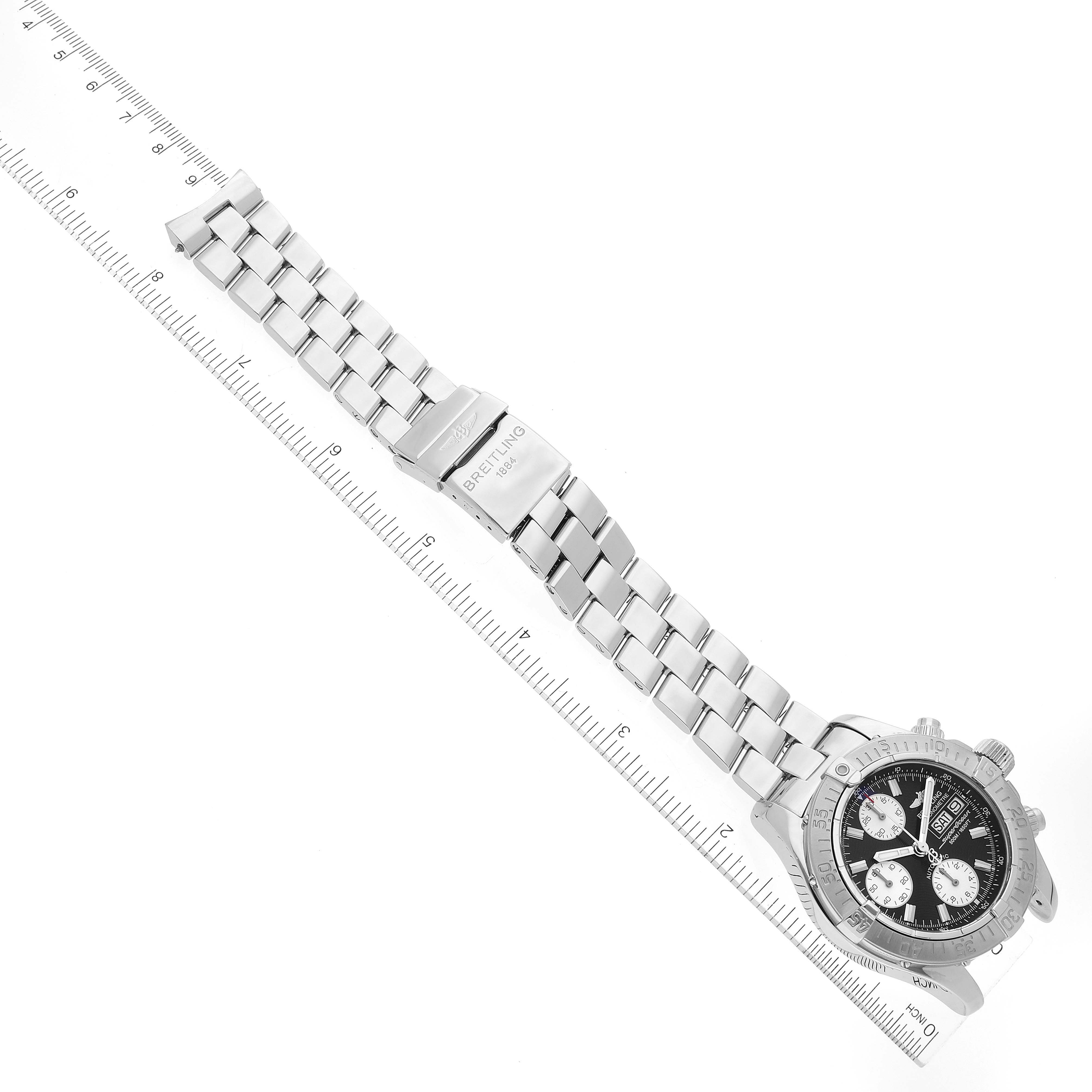 The Breitling Superocean A13340 Men's Stainless Steel Black Dial A13340 Men's Stainless Steel Black Dial watch is shown from an elevated angle, displaying the entire bracelet and face next to a measuring ruler.