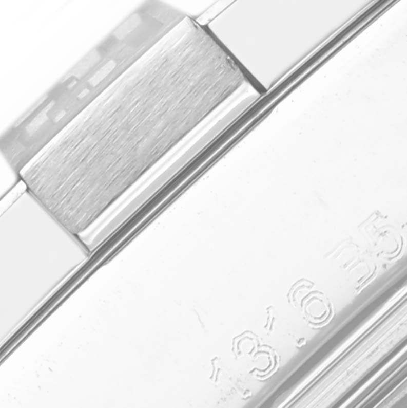 The image shows a close-up of the Breitling Avenger A32390 Men's Stainless Steel Mother of Pearl Dial A32390 Men's Stainless Steel Mother of Pearl Dial's metallic bracelet and engraved numbers on the clasp.