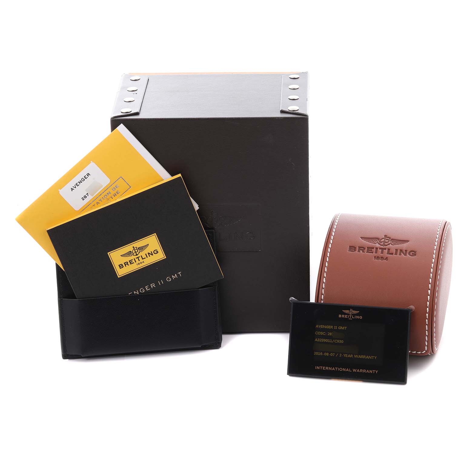 The Breitling Avenger A32390 Men's Stainless Steel Mother of Pearl Dial A32390 Men's Stainless Steel Mother of Pearl Dial watch accessories include a box, leather pouch, warranty card, and instruction booklets, all shown from the front.