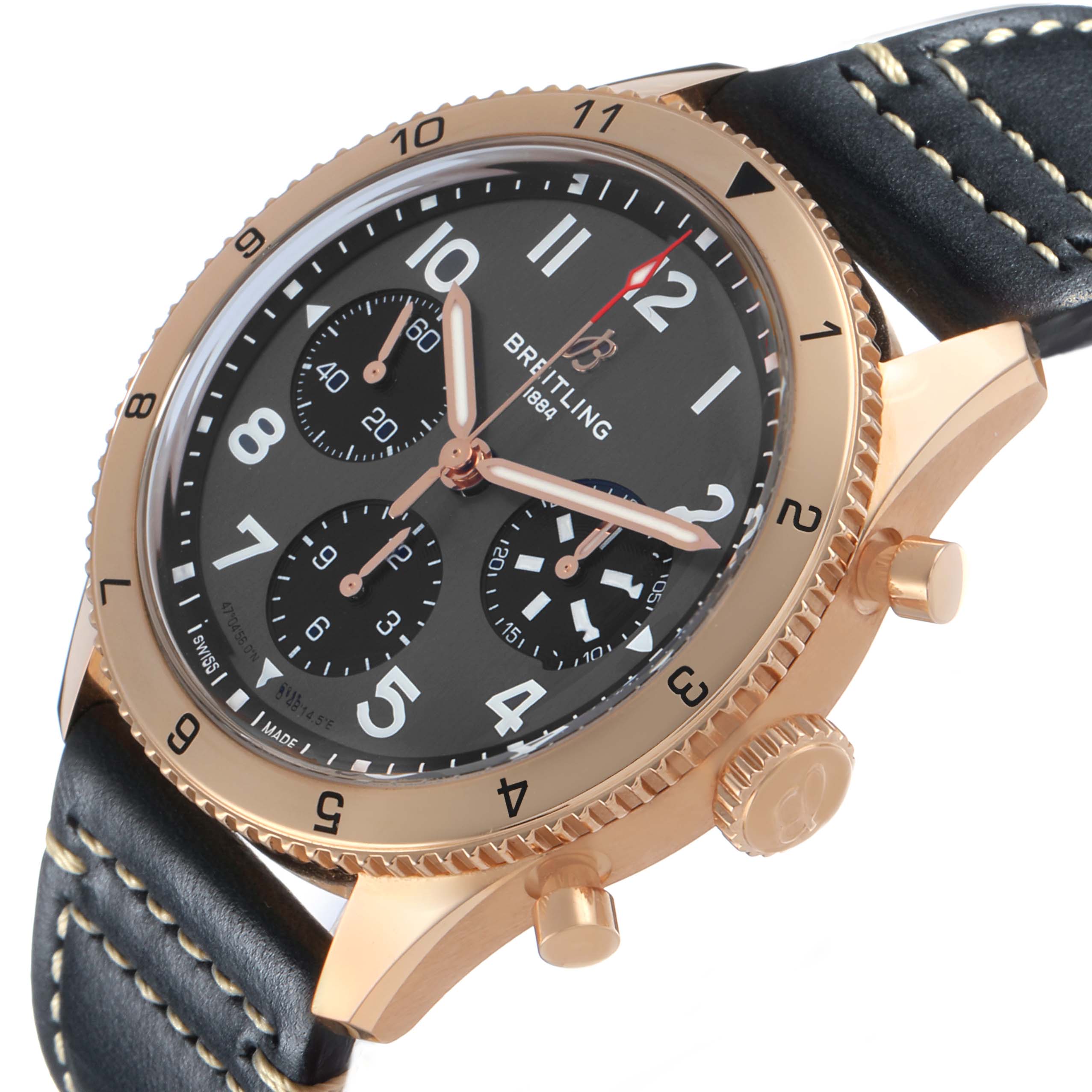 The Breitling Aviator R23380 Men's Rose Gold Grey Dial watch is shown at a slight angle, displaying its face, bezel, crown, pushers, and leather strap.