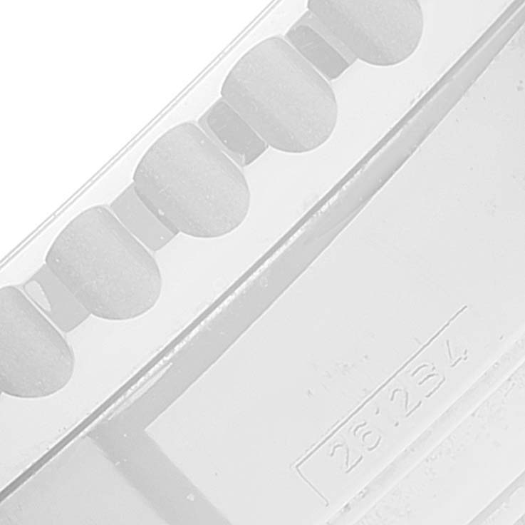 This image shows a close-up of a part of the bracelet and model number engraving on a Breitling Navitimer AB0123 Men's Stainless Steel Silver Dial AB0123 Men's Stainless Steel Silver Dial watch.