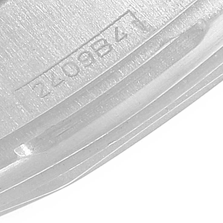 This close-up image shows a partial view of the case back of a Breitling Navitimer A23322 Men's Stainless Steel Silver Dial A23322 Men's Stainless Steel Silver Dial watch with some engraved text visible.