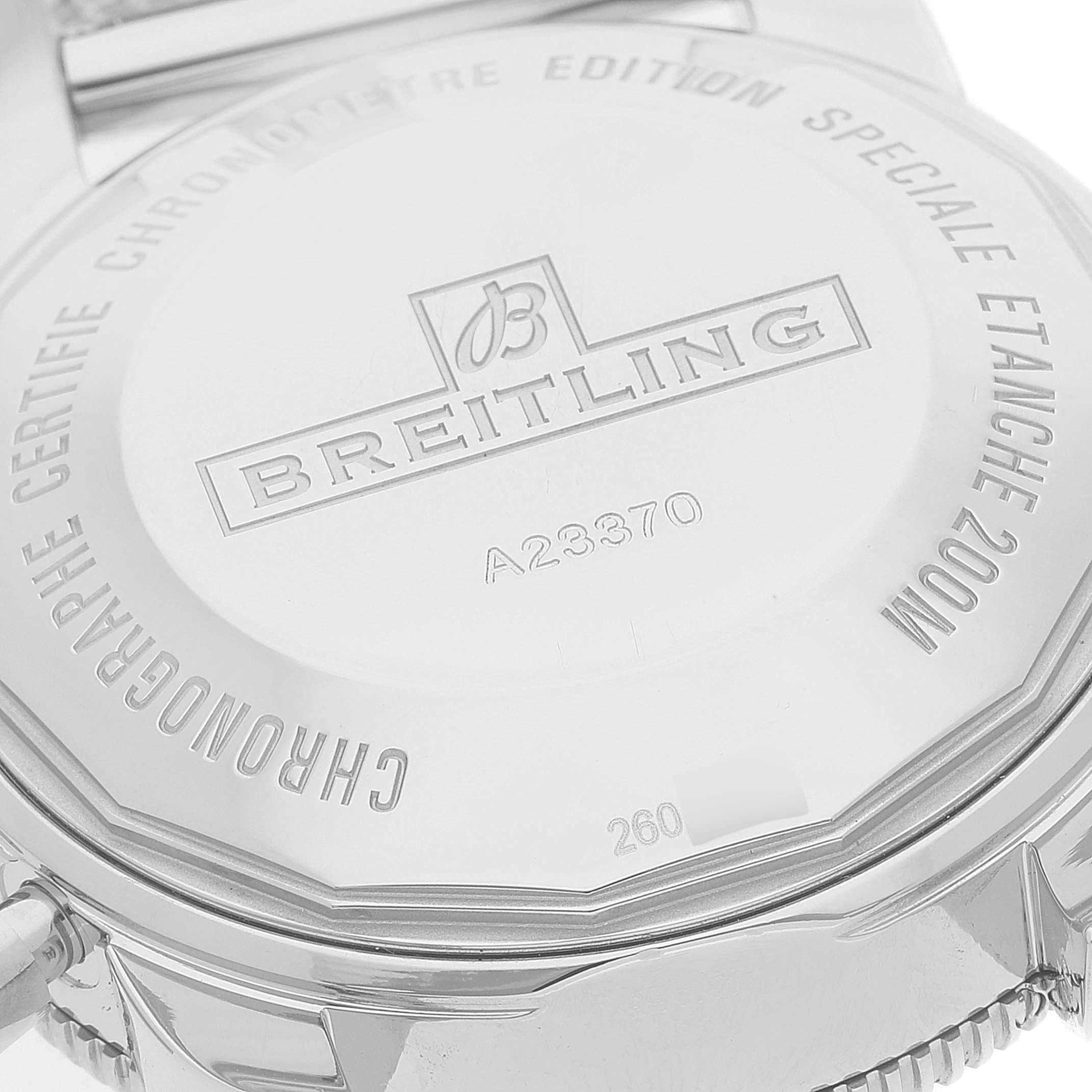 The image shows the back case of a Breitling Superocean A23370 Men's Stainless Steel Blue Dial A23370 Men's Stainless Steel Blue Dial watch, highlighting its engravings and model number.