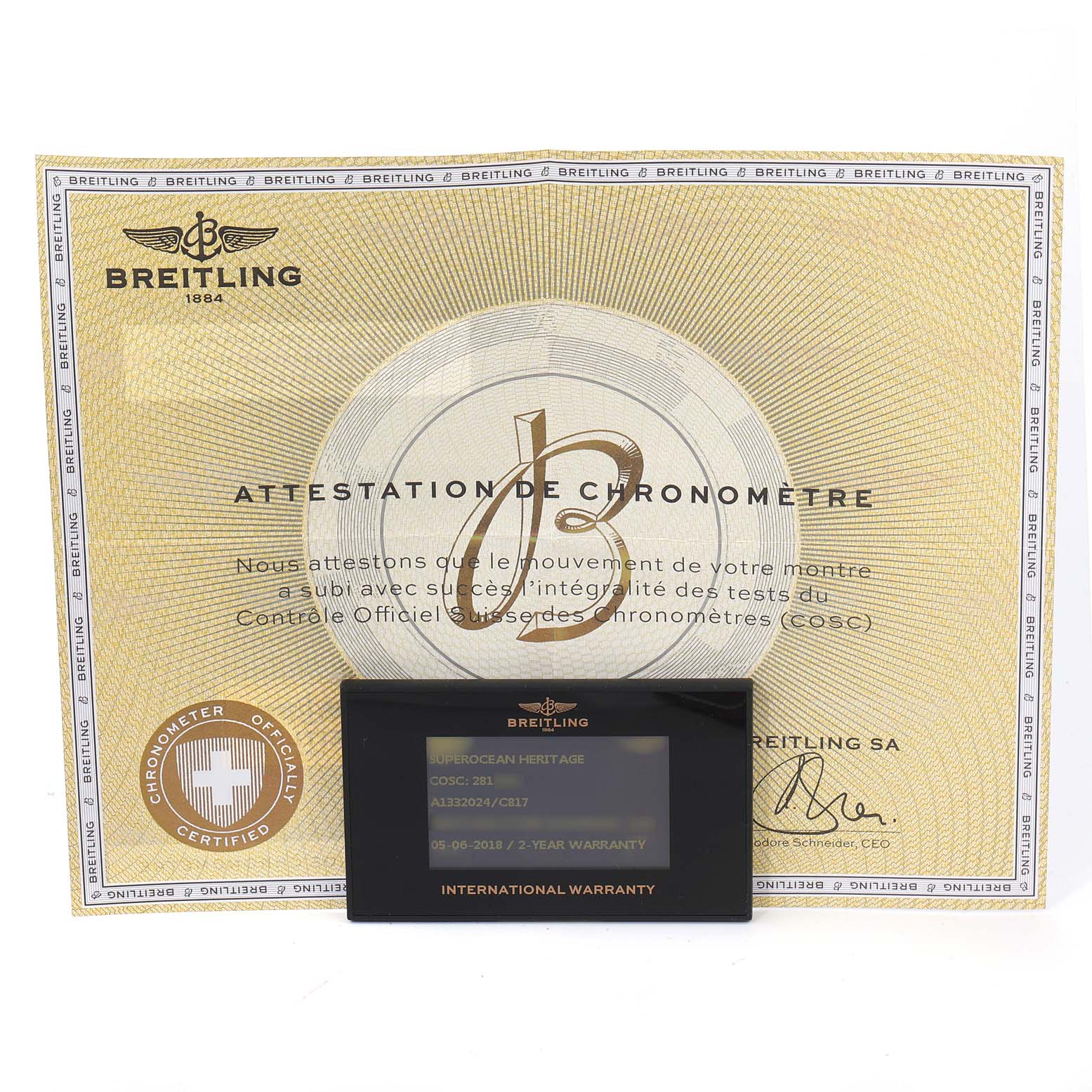 The image shows the Breitling Superocean A13320 Men's Stainless Steel Blue Dial A13320 Men's Stainless Steel Blue Dial model's certificate of authenticity and the international warranty card from a front angle.