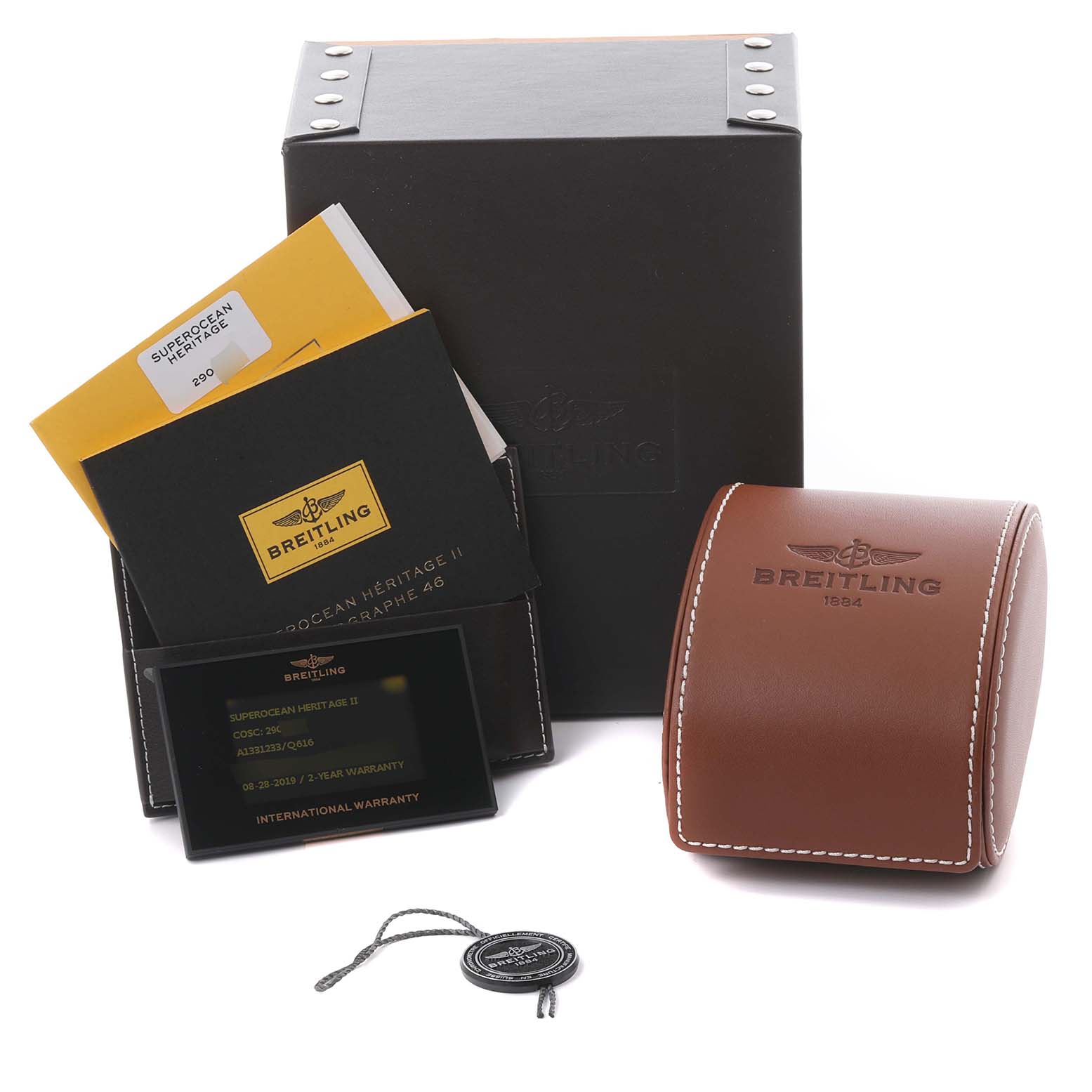 The image shows the Breitling Superocean A1331233/Q616 Men's Stainless Steel Brown Dial A1331233/Q616 Men's Stainless Steel Brown Dial accessories, including a box, a leather case, manuals, and tags, from a front angle.