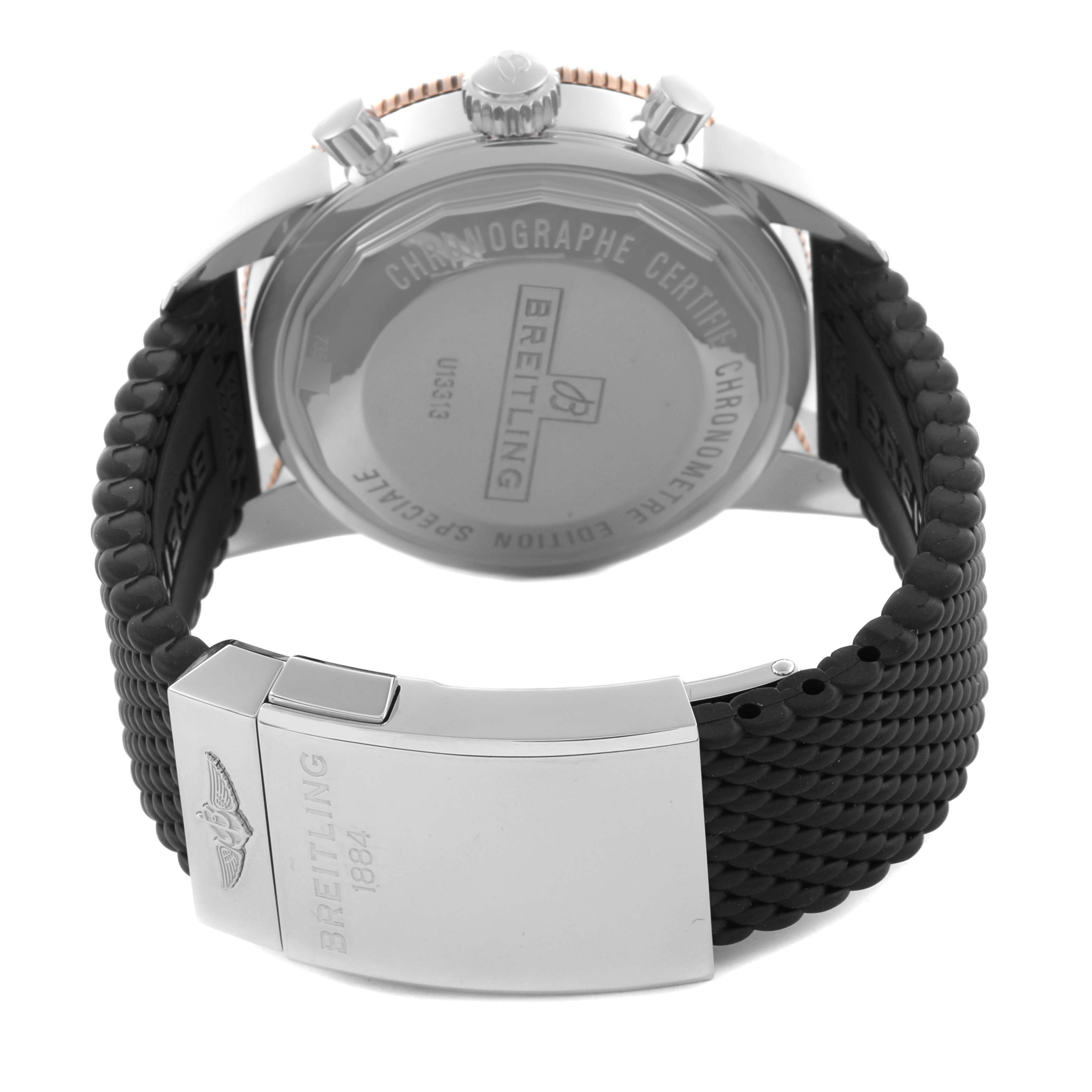 The image shows the back of a Breitling Superocean U13313 Men's Steel and Gold (two tone) Black Dial U13313 Men's Steel and Gold (two tone) Black Dial watch, highlighting the stainless steel case back, crown, and rubber strap with clasp.