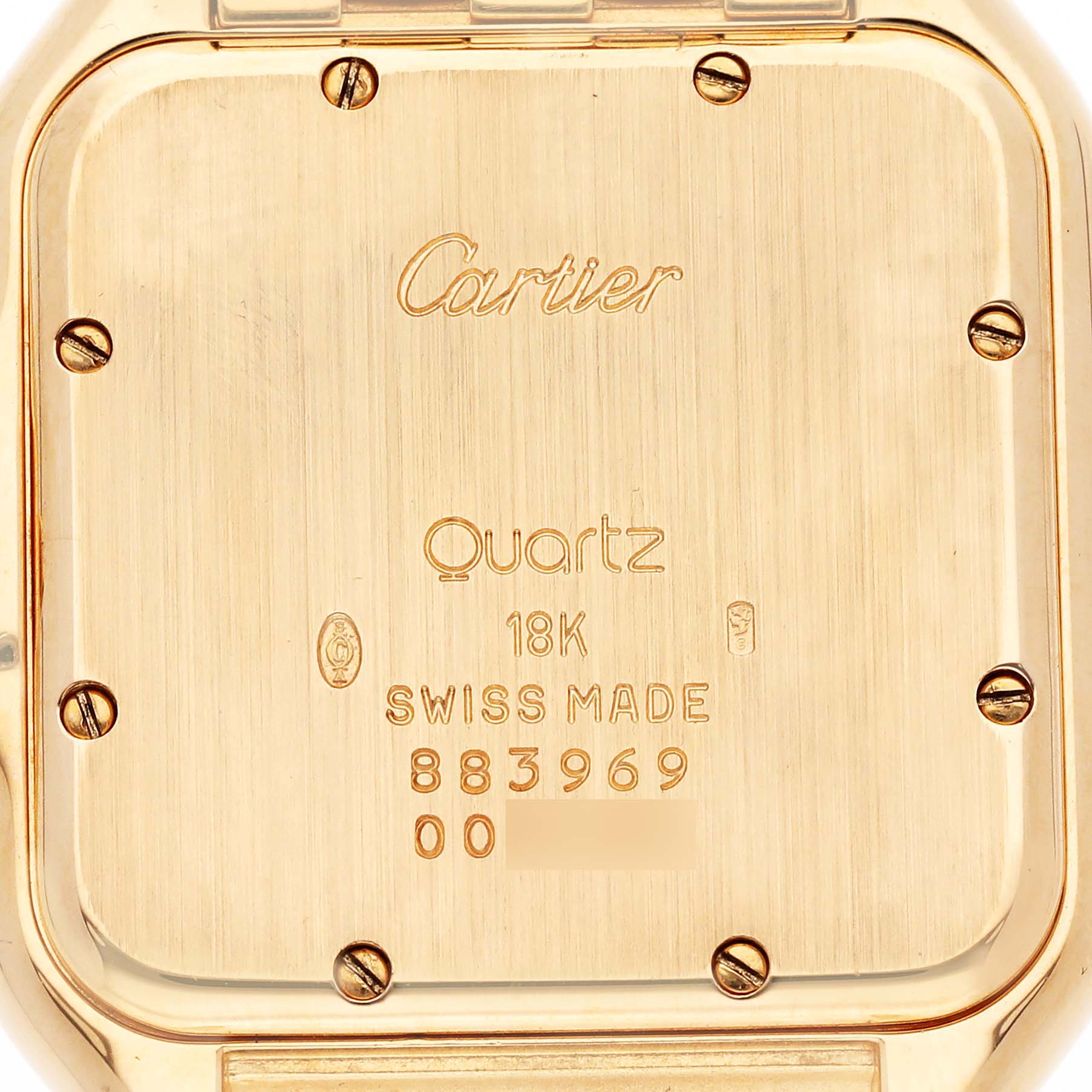 The image shows the back case of a Cartier Panthere 883969 Men's Yellow Gold Silver Dial 883969 Men's Yellow Gold Silver Dial model, highlighting engravings and screw details.