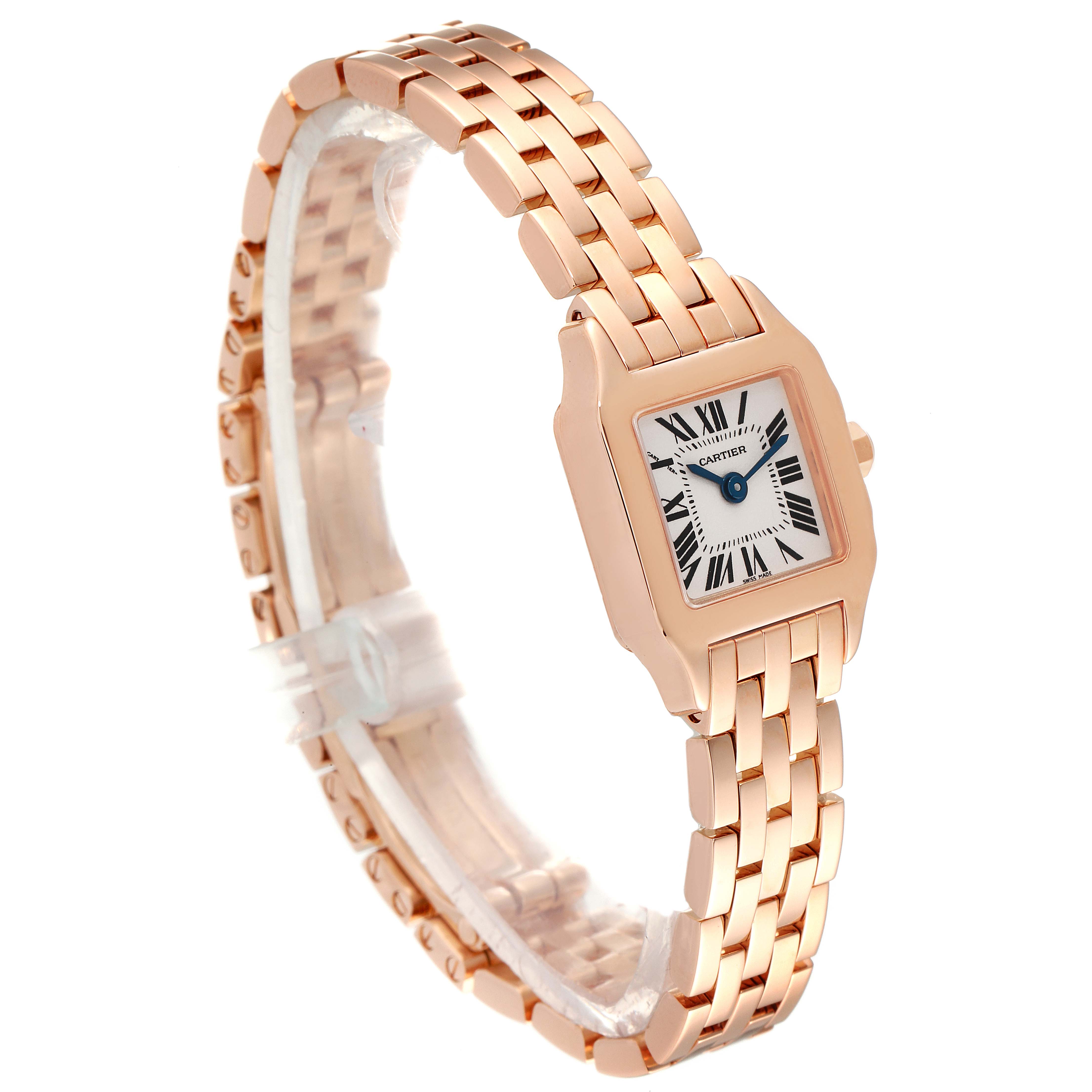 The Cartier Santos Demoiselle W25077X9 Women
s Rose Gold Silver Dial W25077X9 Women
s Rose Gold Silver Dial watch is shown at a three-quarter angle, revealing the rose gold bracelet and square case with Roman numeral dial.