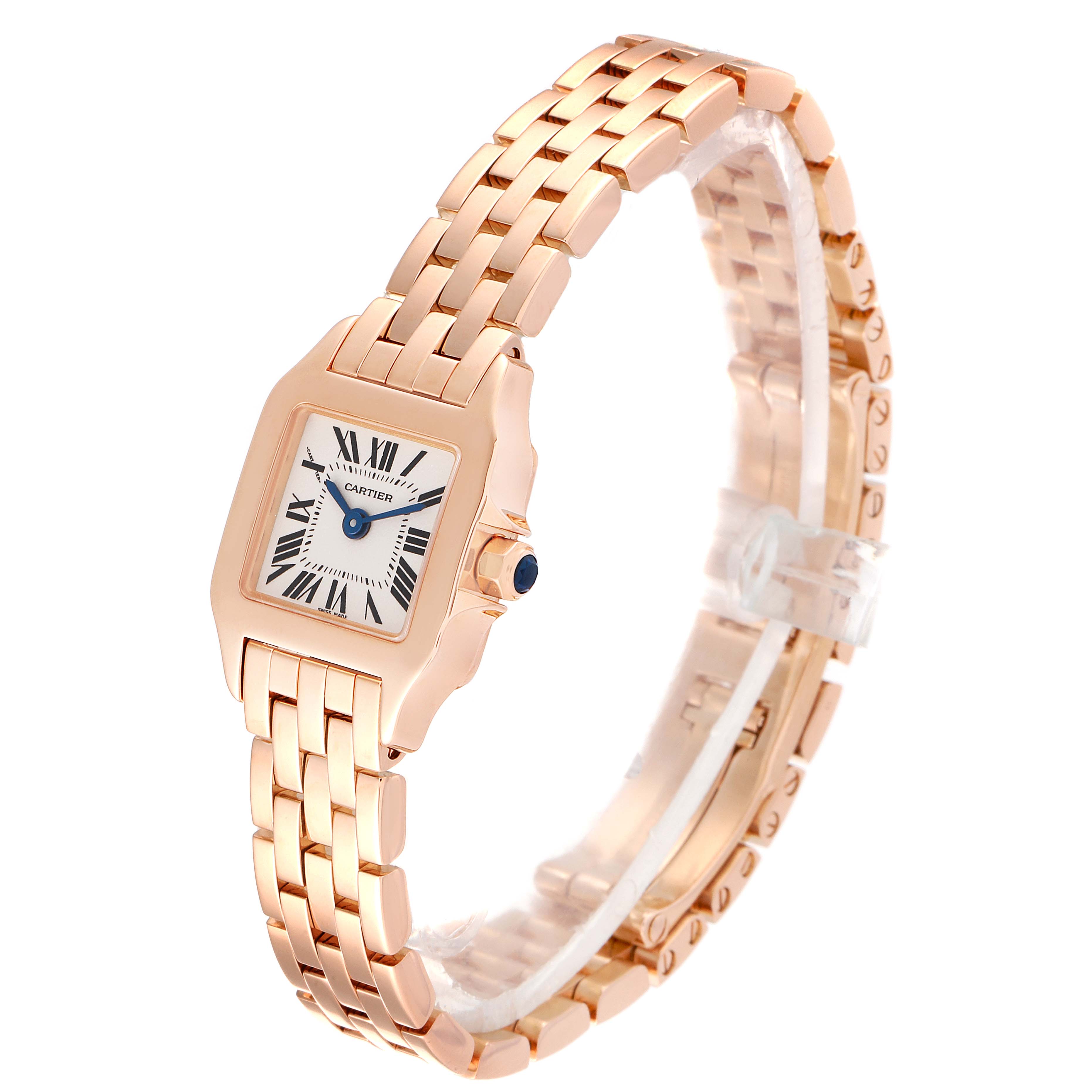 The image shows a Cartier Santos Demoiselle W25077X9 Women
s Rose Gold Silver Dial W25077X9 Women
s Rose Gold Silver Dial watch at an angle highlighting the face, bracelet, and crown with a blue stone.