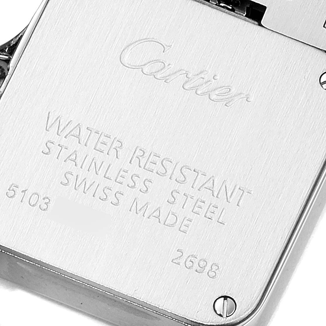 The image shows the back of a Santos Demoiselle model by Cartier, highlighting the engraved details and screws.