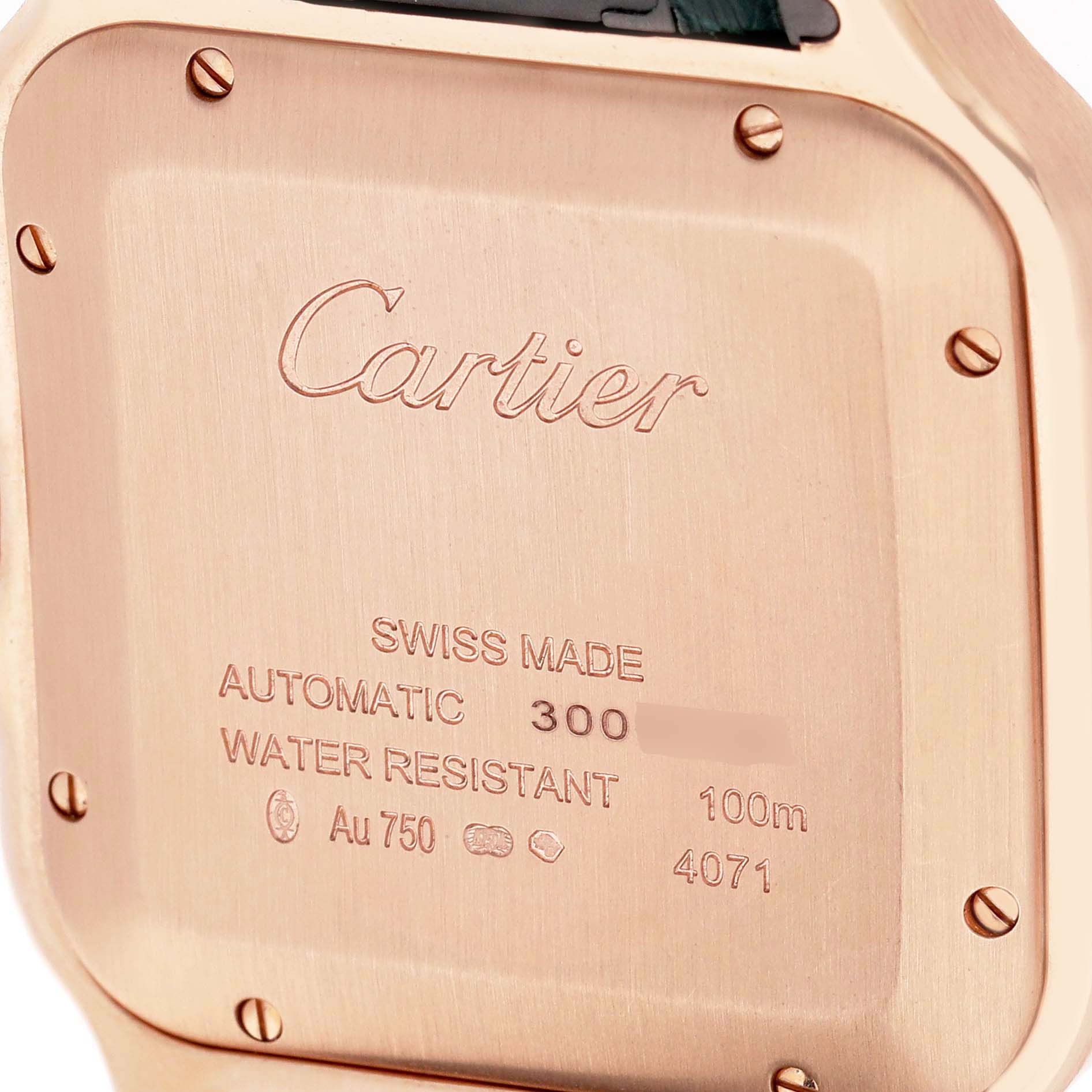 The image shows the back of a Cartier Santos WGSA0011 Men's Rose Gold Silver Dial watch, displaying engravings and screws.