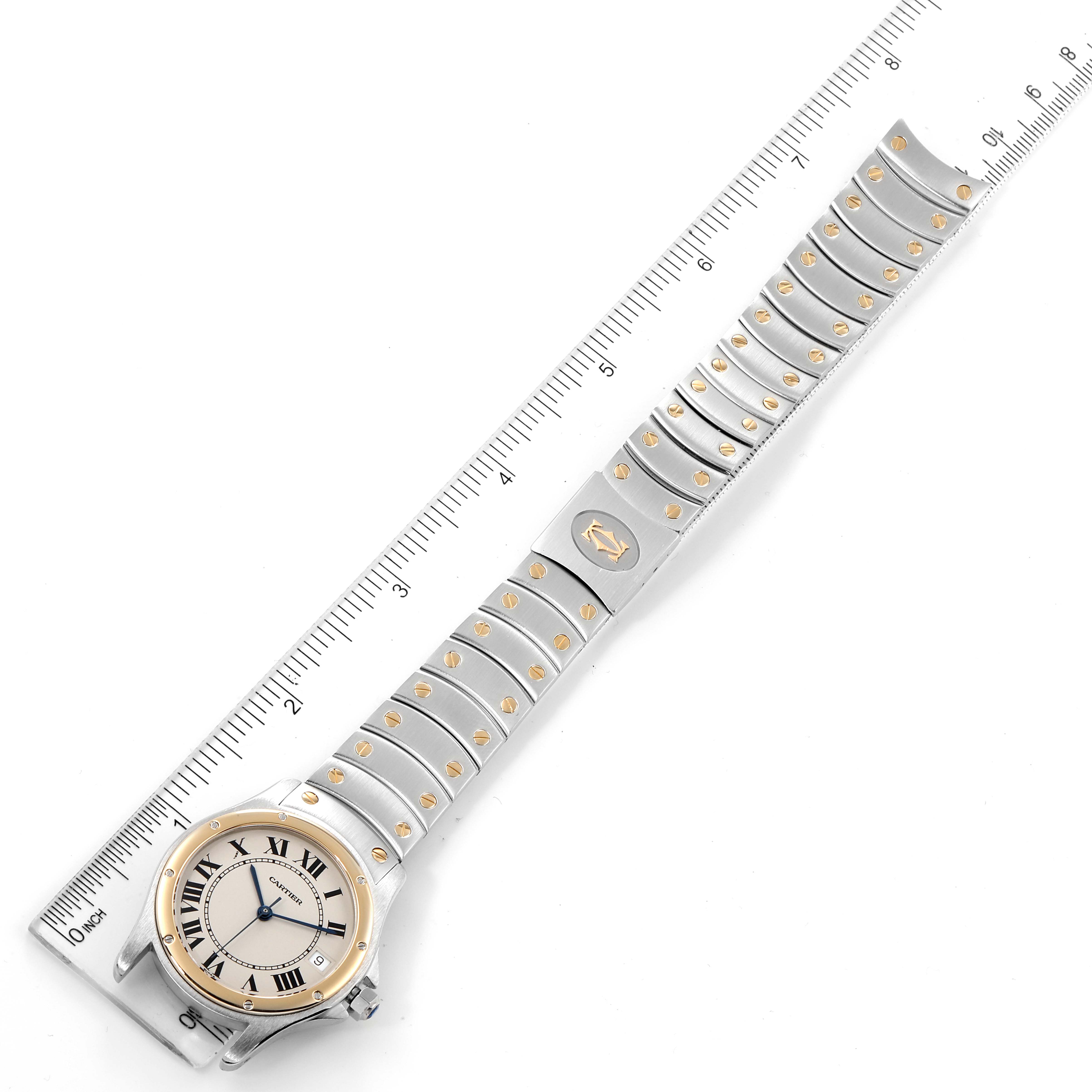 The image shows a top-down view of the Cartier Santos W20028G1 Men
s Steel and Gold (two tone) Silver Dial W20028G1 Men
s Steel and Gold (two tone) Silver Dial model watch, displaying the entire watch and a measuring ruler beside it.