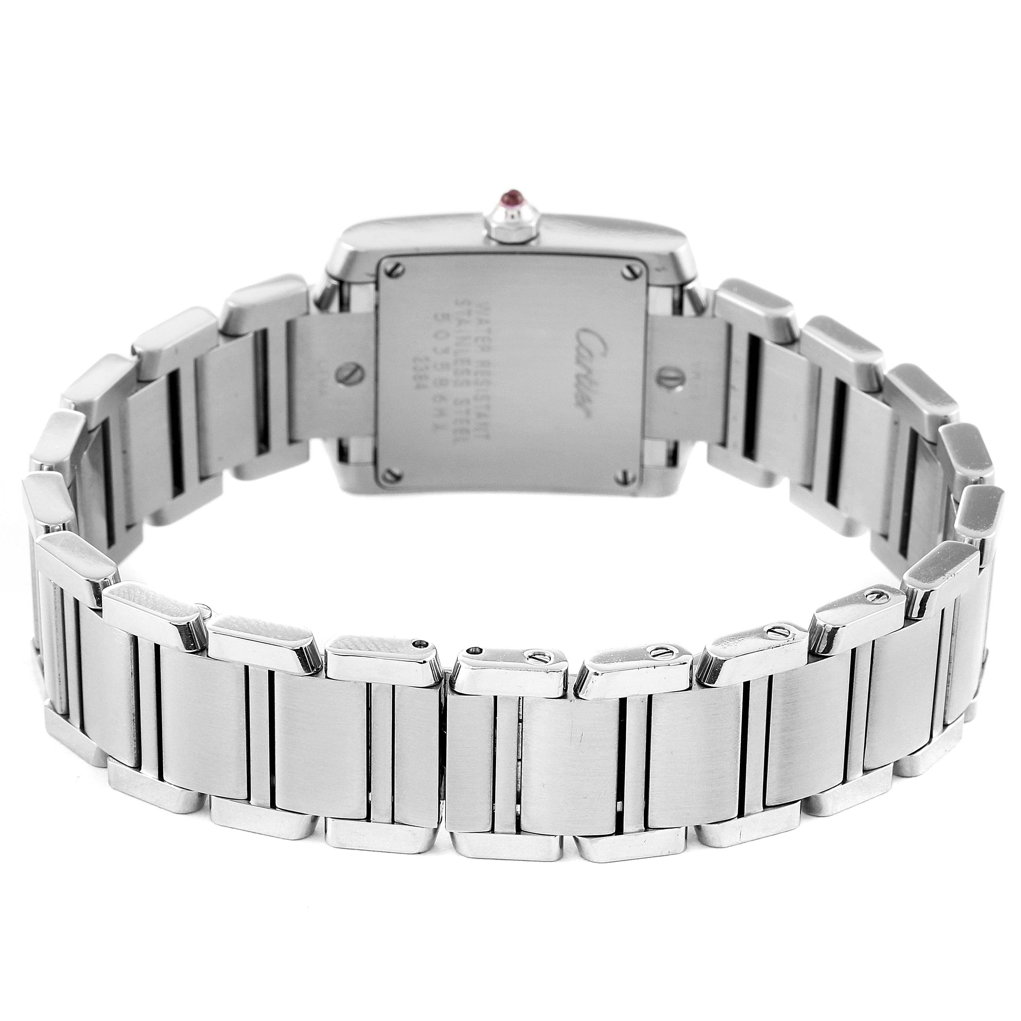 The image shows the back view of a Cartier Tank Française watch, highlighting its stainless steel bracelet and case.