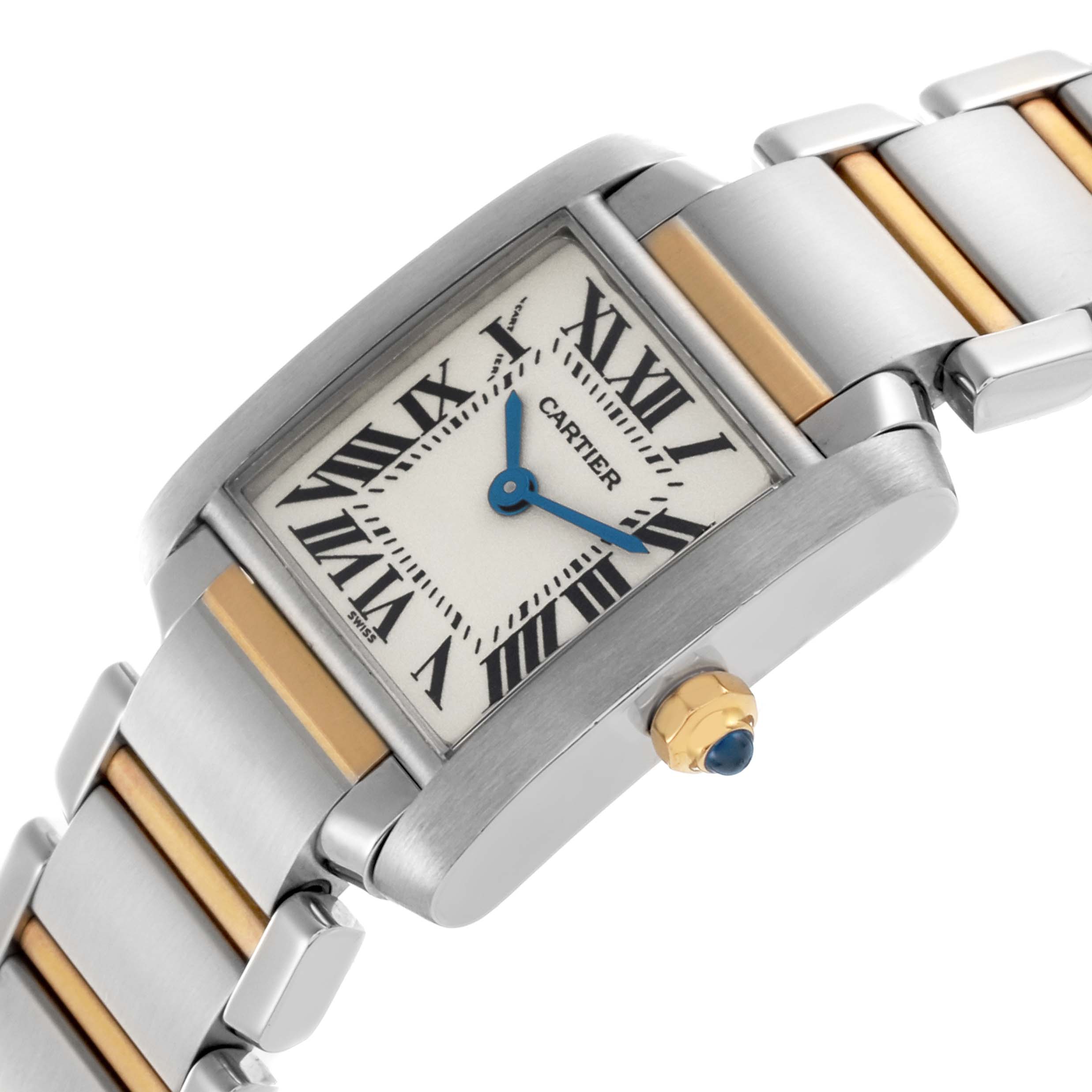 The Cartier Tank Française watch is shown at an angle displaying the face, blue hands, Roman numerals, crown, and two-tone bracelet.