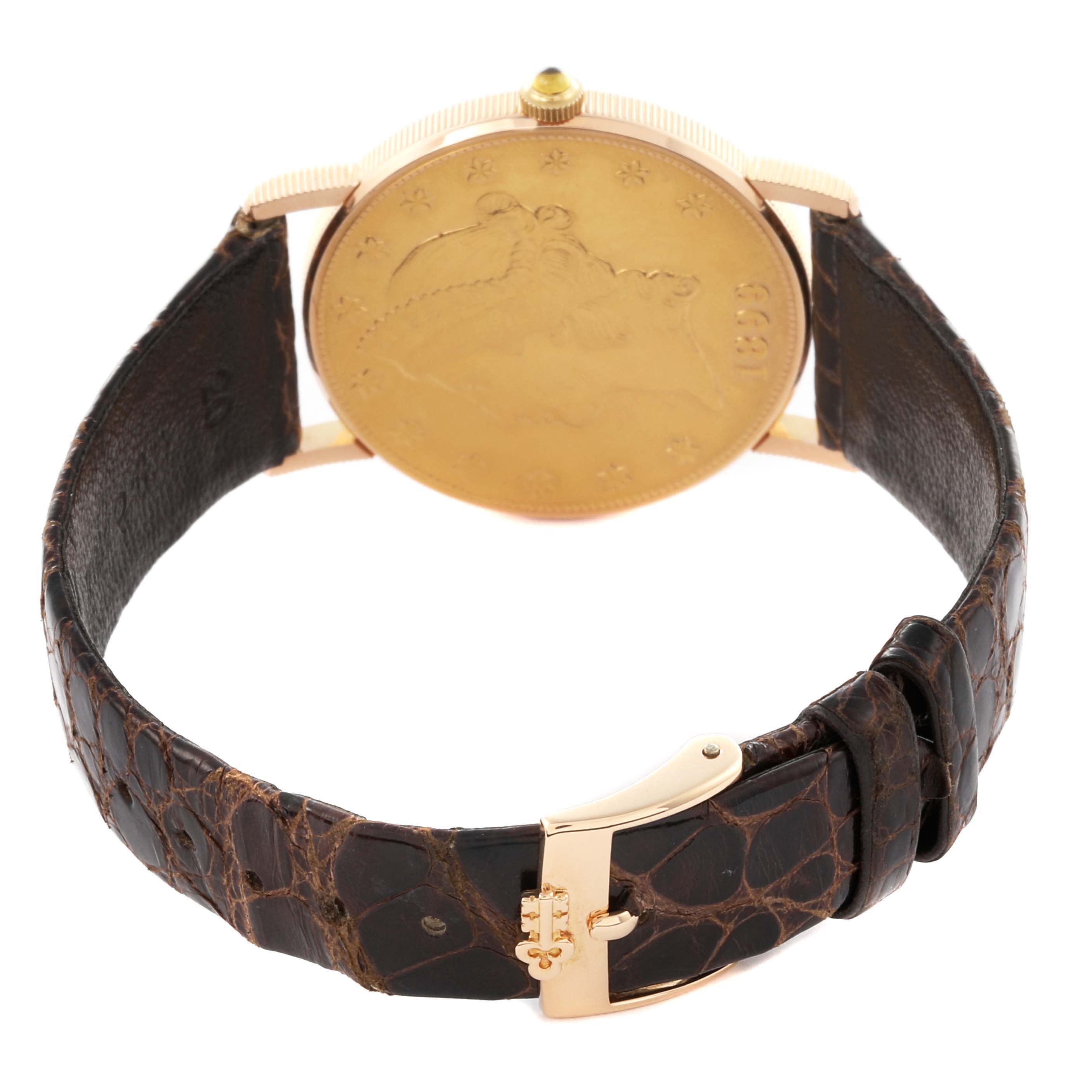 The Corum Coin Watch 4414556 Men's Yellow Gold Champagne Dial 4414556 Men's Yellow Gold Champagne Dial is shown from the back, highlighting its coin design and leather strap with a gold buckle.