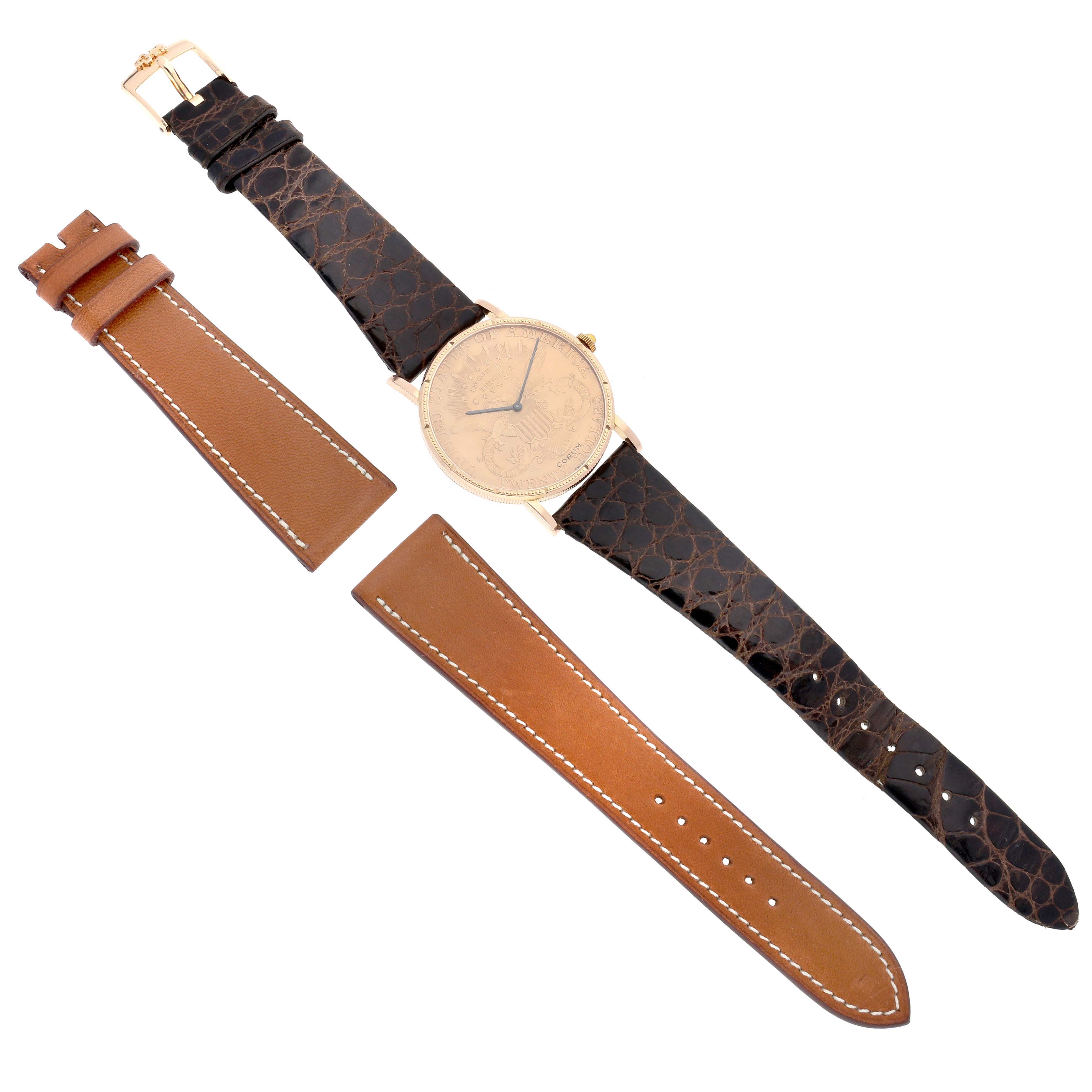 The image shows a Corum Coin Watch 4414556 Men's Yellow Gold Champagne Dial 4414556 Men's Yellow Gold Champagne Dial from a top-down angle with a black leather strap and an additional brown leather strap.