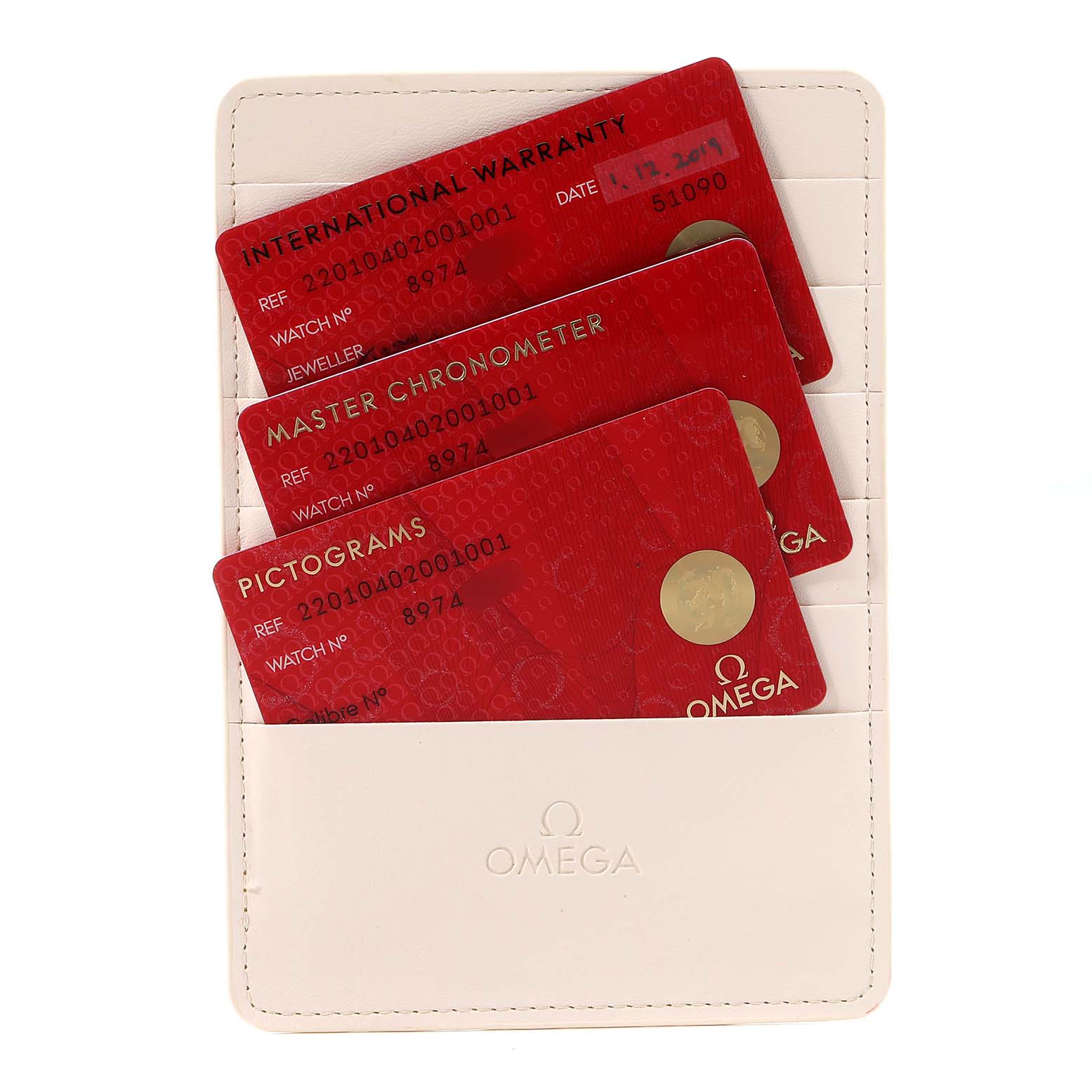 The image shows warranty cards and certifications for an Omega Aqua Terra 220.10.40.20.01.001 Men's Stainless Steel Black Dial 220.10.40.20.01.001 Men's Stainless Steel Black Dial watch, held in a white Omega cardholder.