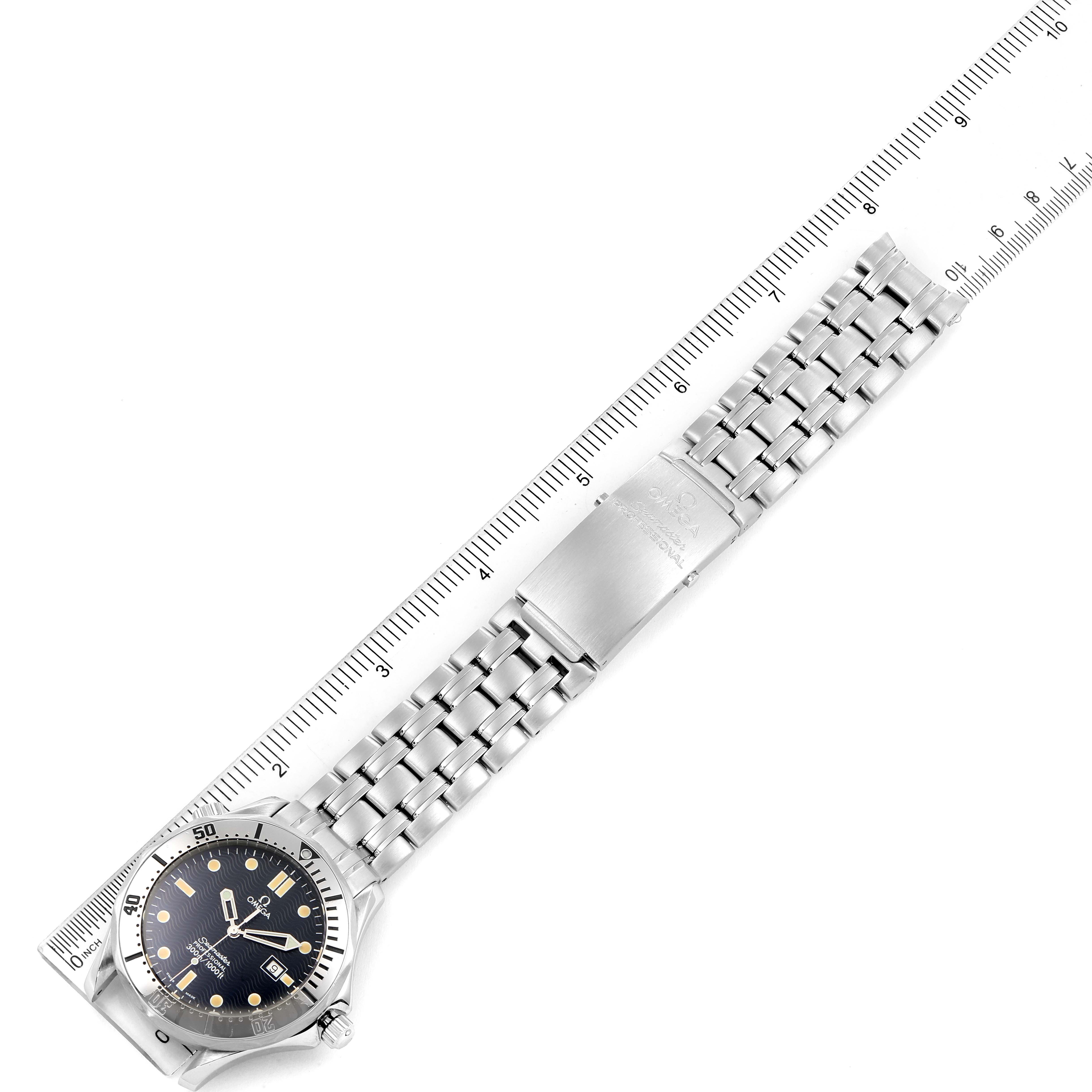 The image shows a top-down view of an Omega Seamaster 2542.80.00 Men
s Stainless Steel Blue Dial 2542.80.00 Men
s Stainless Steel Blue Dial watch with a stainless steel bracelet next to a ruler for measurement.