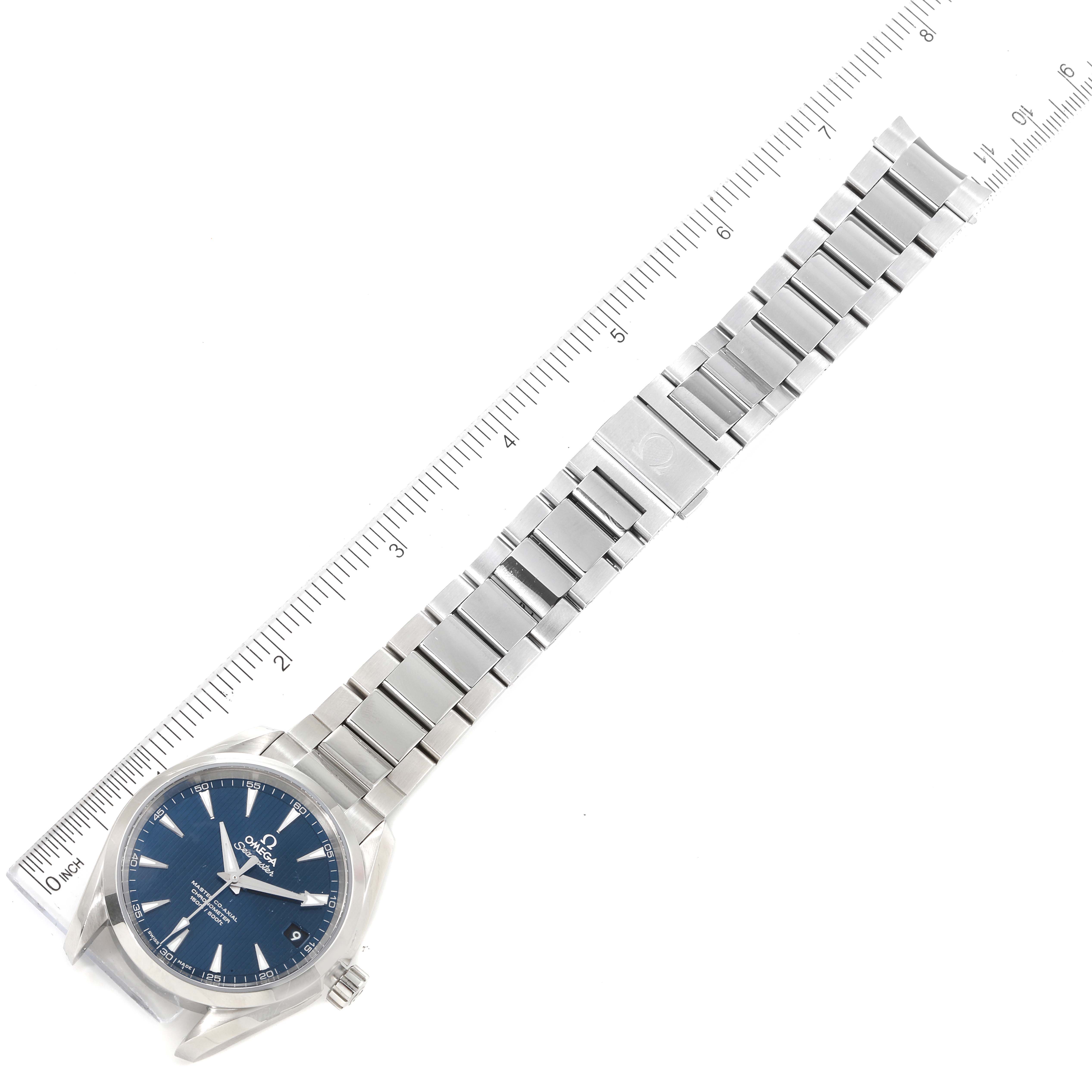 This image shows the Omega Aqua Terra 231.10.39.21.03.002 Men
s Stainless Steel Blue Dial 231.10.39.21.03.002 Men
s Stainless Steel Blue Dial watch laid flat, highlighting the face, bezel, crown, and metal bracelet alongside a ruler.